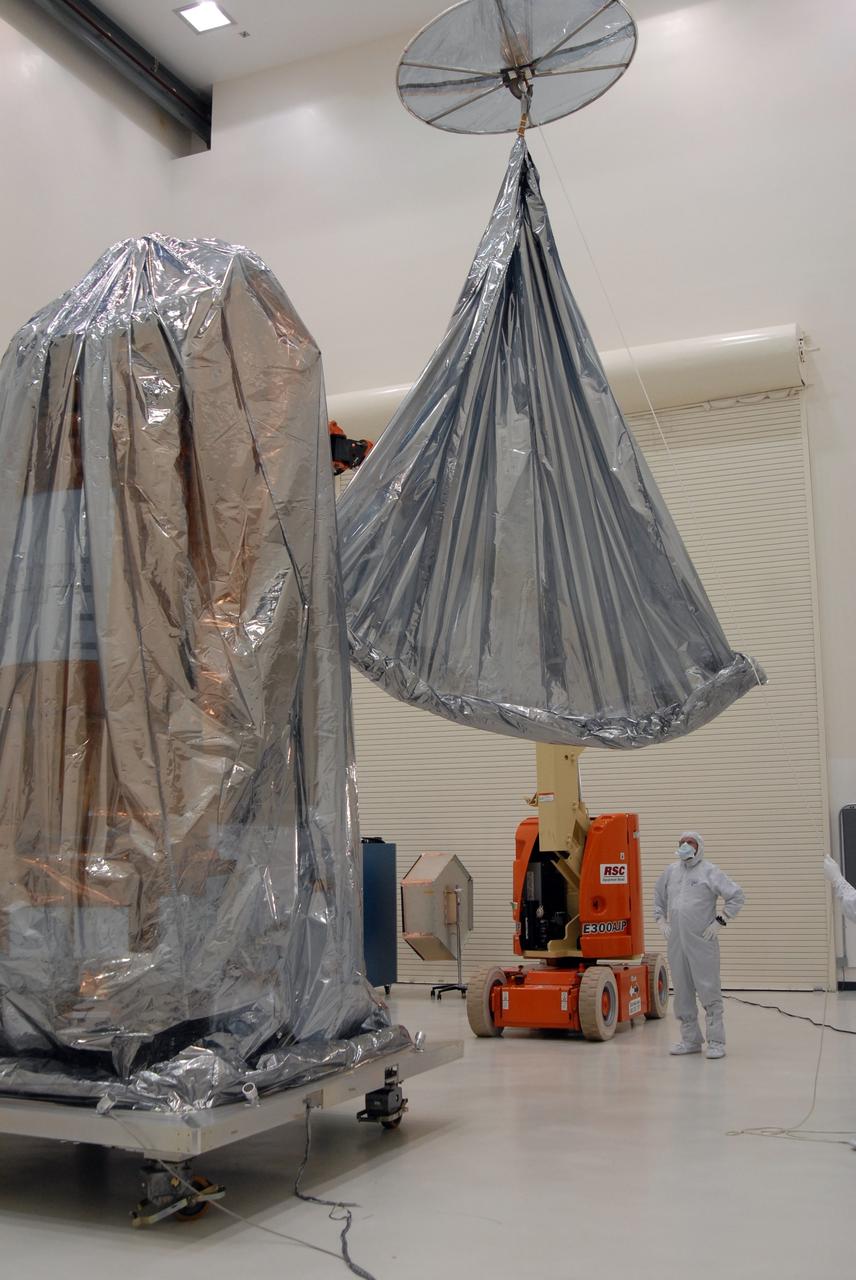 CAPE CANAVERAL, Fla. – At the Astrotech payload processing facility, another protective cover is lowered over NASA's Kepler spacecraft. When covered, Kepler will be moved to the Hazardous Processing Facility for fueling. Kepler is designed to survey more than 100,000 stars in our galaxy to determine the number of sun-like stars that have Earth-size and larger planets, including those that lie in a star's "habitable zone," a region where liquid water, and perhaps life, could exist. If these Earth-size worlds do exist around stars like our sun, Kepler is expected to be the first to find them and the first to measure how common they are. The liftoff of Kepler aboard a Delta II rocket is currently planned for 10:48 p.m. EST March 5 from Space Launch Complex 17 on Cape Canaveral Air Force Station. Photo credit: NASA/Jack Pfaller