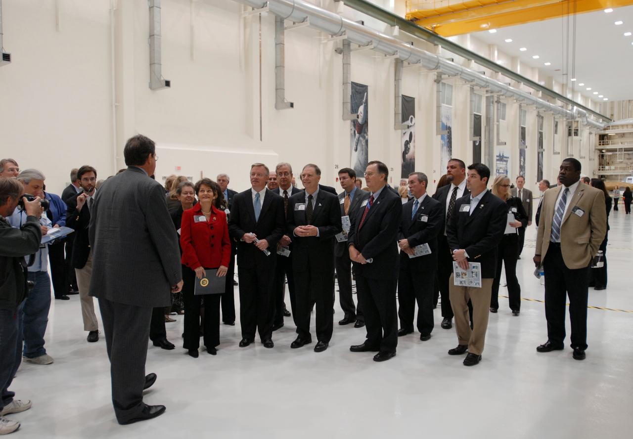 CAPE CANAVERAL, Fla. – Representatives from NASA, Lockheed Martin, Space Florida and the state of Florida participate in a ceremony at NASA's Kennedy Space Center in Florida to mark the completion of renovations on the historic Operations and Checkout Building high bay for use by the Constellation Program. At left, Richard Harris, with Lockheed Martin, describes activities that will take place in the building. In front of him are U.S. Rep. Suzanne Kosmas and Lt. Governor Jeff Kottcamp. Originally built to process space vehicles in the Apollo era, the building will serve as the final assembly facility for the Orion crew exploration vehicle. Orion, America's future human spaceflight vehicle, will be capable of transporting four crew members to the moon and later will support crew transfers to Mars. The Orion spacecraft also will be used to transport crew members to the International Space Station after space shuttles are retired in 2010. The first operational launch of Orion atop an Ares I rocket is planned for 2015. Photo credit: NASA/Dimitri Gerondidakis