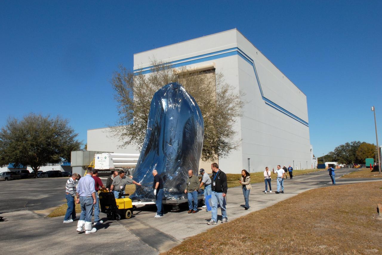 CAPE CANAVERAL, Fla. – Thoroughly wrapped for travel, NASA's Kepler spacecraft is moved to the Hazardous Processing Facility at Astrotech in Titusville, Fla., for fueling. Kepler is designed to survey more than 100,000 stars in our galaxy to determine the number of sun-like stars that have Earth-size and larger planets, including those that lie in a star's "habitable zone," a region where liquid water, and perhaps life, could exist. If these Earth-size worlds do exist around stars like our sun, Kepler is expected to be the first to find them and the first to measure how common they are. The liftoff of Kepler aboard a Delta II rocket is currently planned for 10:48 p.m. EST March 5 from Space Launch Complex 17 on Cape Canaveral Air Force Station. Photo credit: NASA/Tim Jacobs