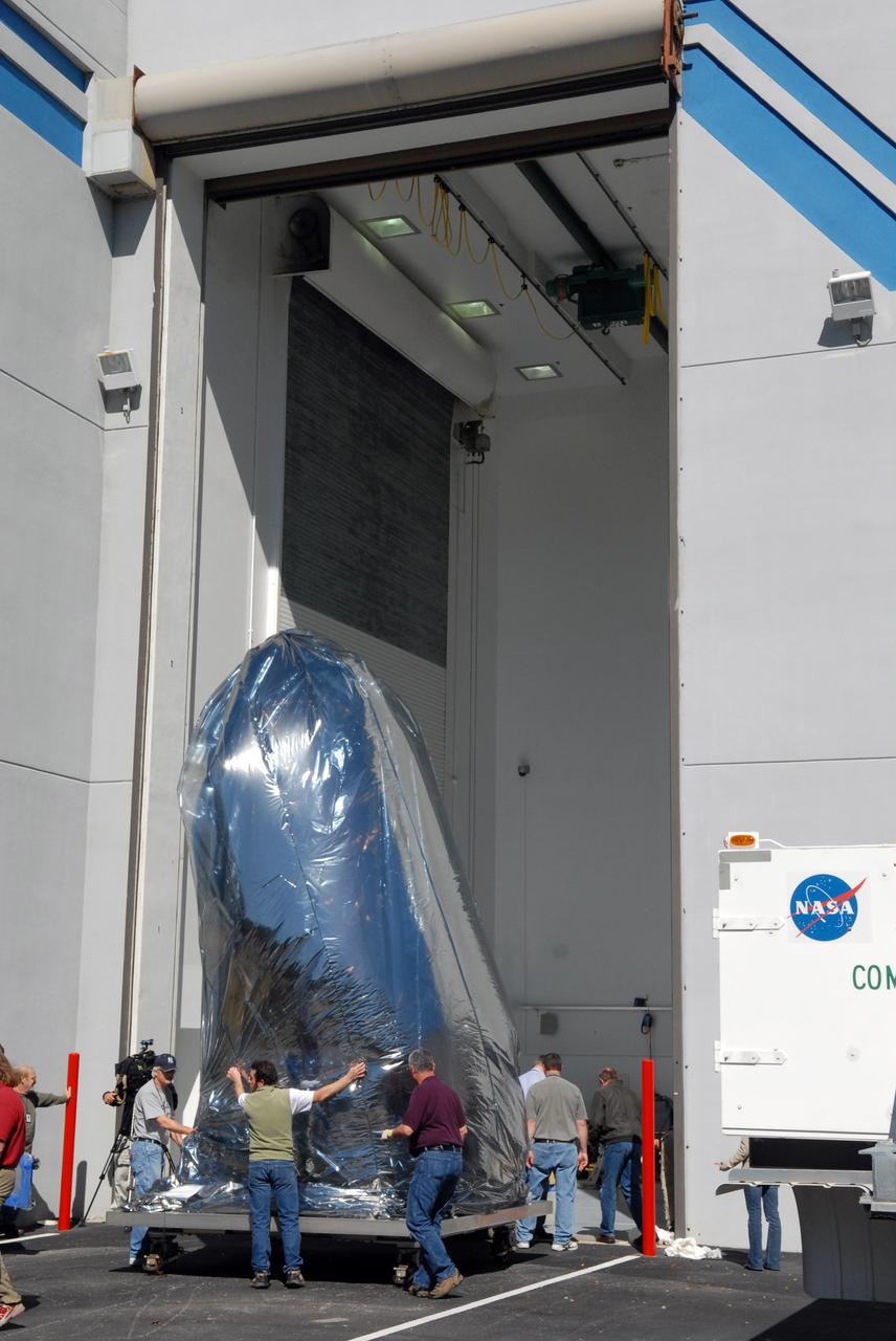 CAPE CANAVERAL, Fla. – Thoroughly wrapped for travel, NASA's Kepler spacecraft is moved into the Hazardous Processing Facility at Astrotech in Titusville, Fla., for fueling. Kepler is designed to survey more than 100,000 stars in our galaxy to determine the number of sun-like stars that have Earth-size and larger planets, including those that lie in a star's "habitable zone," a region where liquid water, and perhaps life, could exist. If these Earth-size worlds do exist around stars like our sun, Kepler is expected to be the first to find them and the first to measure how common they are. The liftoff of Kepler aboard a Delta II rocket is currently planned for 10:48 p.m. EST March 5 from Space Launch Complex 17 on Cape Canaveral Air Force Station. Photo credit: NASA/Tim Jacobs