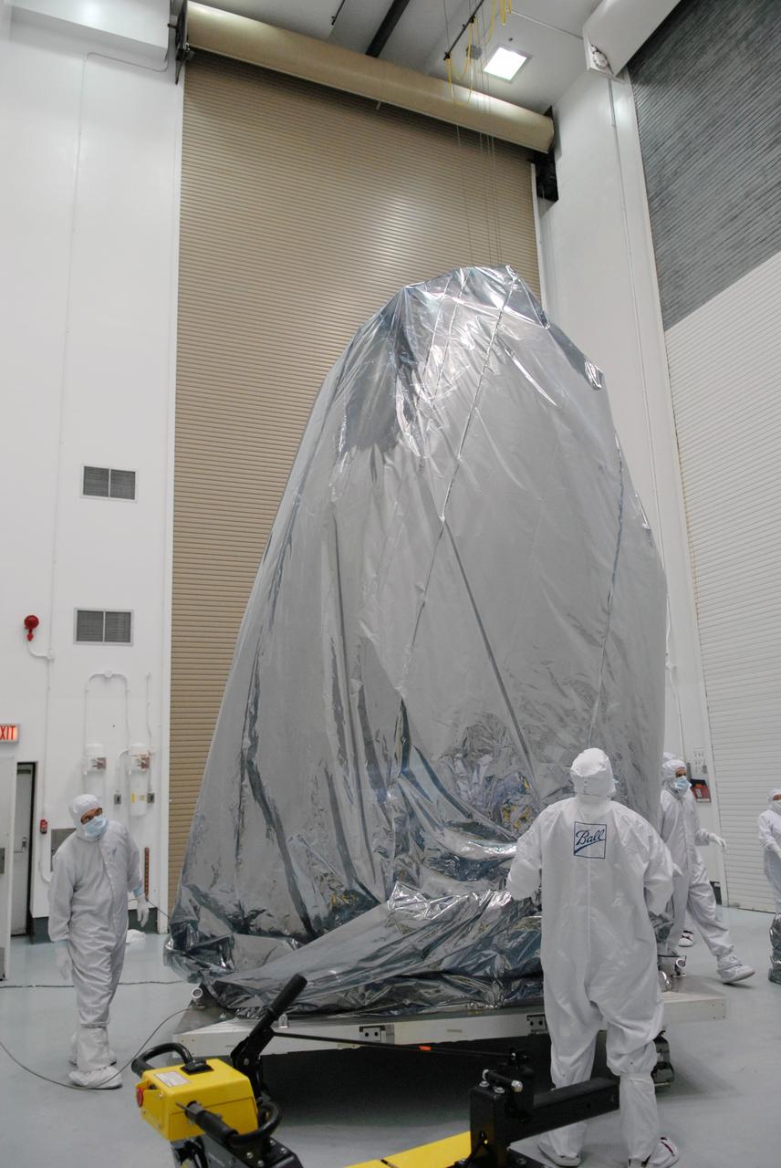 CAPE CANAVERAL, Fla. – Inside the Hazardous Processing Facility at Astrotech in Titusville, Fla., NASA's Kepler spacecraft is being unwrapped to prepare for fueling. Kepler is designed to survey more than 100,000 stars in our galaxy to determine the number of sun-like stars that have Earth-size and larger planets, including those that lie in a star's "habitable zone," a region where liquid water, and perhaps life, could exist. If these Earth-size worlds do exist around stars like our sun, Kepler is expected to be the first to find them and the first to measure how common they are.  The liftoff of Kepler aboard a Delta II rocket is currently planned for 10:48 p.m. EST March 5 from Space Launch Complex 17 on Cape Canaveral Air Force Station.   Photo credit: NASA/Tim Jacobs