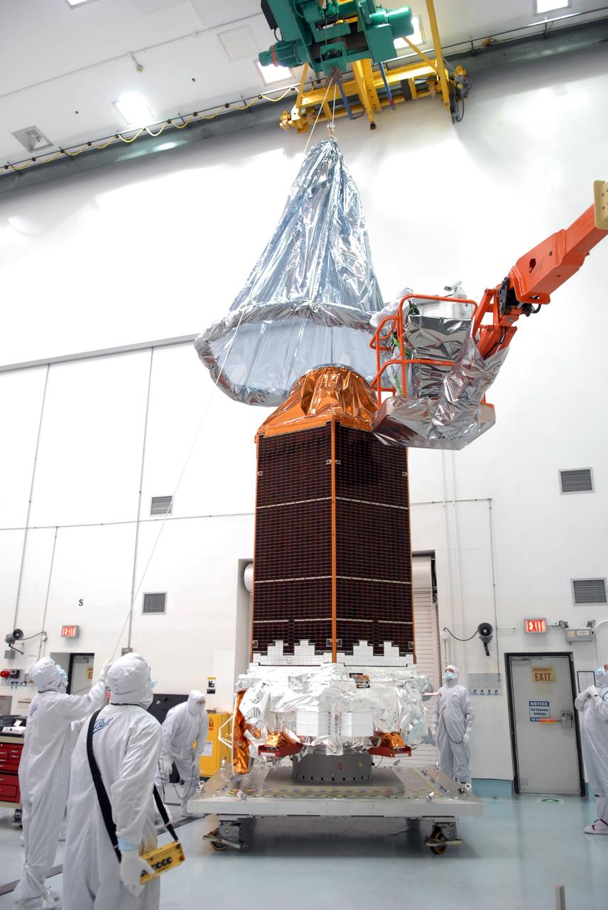 CAPE CANAVERAL, Fla. – Inside the Hazardous Processing Facility at Astrotech in Titusville, Fla., the final cover is removed from NASA's Kepler spacecraft. Kepler will be fueled for launch. Kepler is designed to survey more than 100,000 stars in our galaxy to determine the number of sun-like stars that have Earth-size and larger planets, including those that lie in a star's "habitable zone," a region where liquid water, and perhaps life, could exist. If these Earth-size worlds do exist around stars like our sun, Kepler is expected to be the first to find them and the first to measure how common they are. The liftoff of Kepler aboard a Delta II rocket is currently planned for 10:48 p.m. EST March 5 from Space Launch Complex 17 on Cape Canaveral Air Force Station. Photo credit: NASA/Tim Jacobs