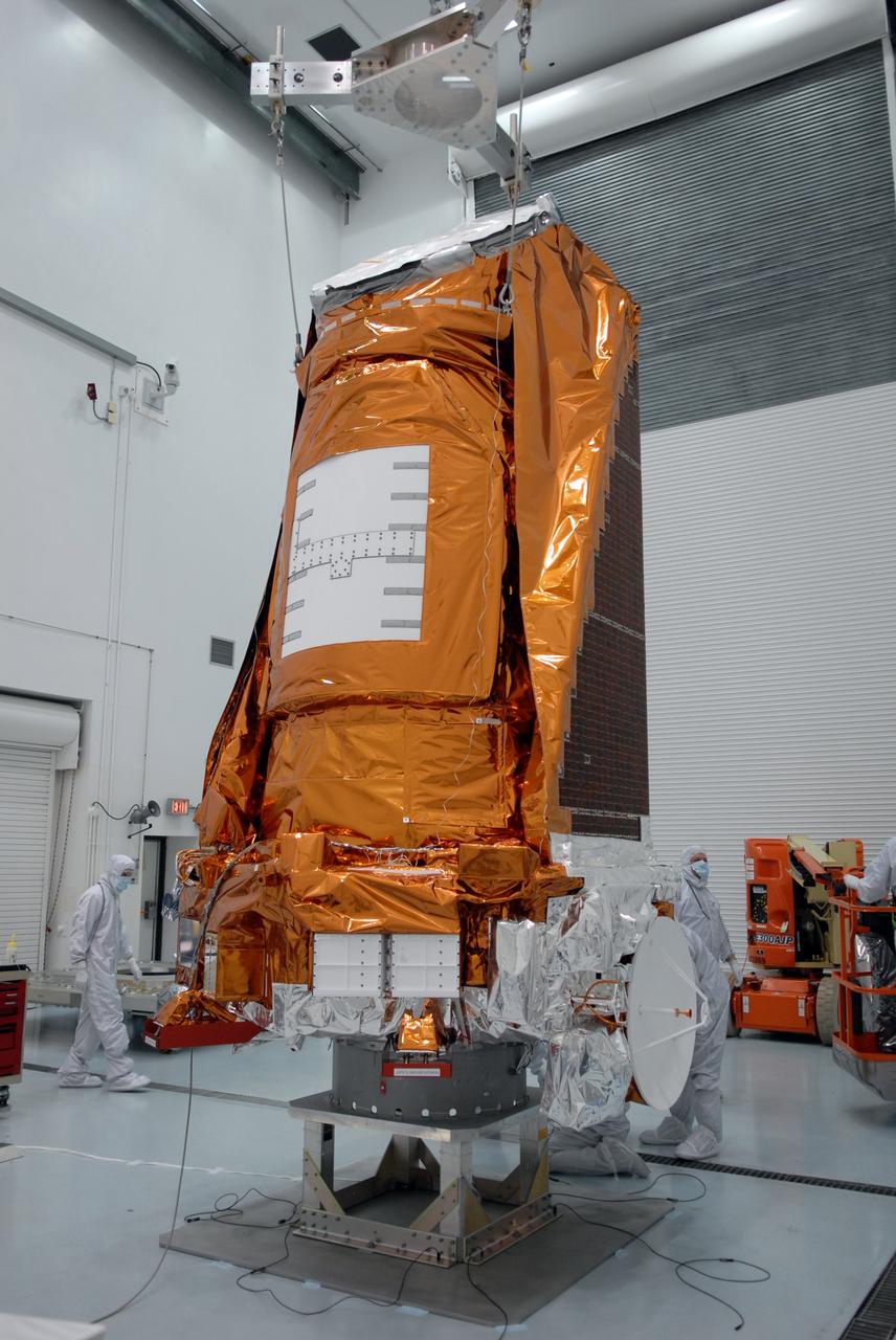 CAPE CANAVERAL, Fla. – Inside the Hazardous Processing Facility at Astrotech in Titusville, Fla., NASA's Kepler spacecraft is lowered onto a stand for fueling. Kepler is designed to survey more than 100,000 stars in our galaxy to determine the number of sun-like stars that have Earth-size and larger planets, including those that lie in a star's "habitable zone," a region where liquid water, and perhaps life, could exist. If these Earth-size worlds do exist around stars like our sun, Kepler is expected to be the first to find them and the first to measure how common they are. The liftoff of Kepler aboard a Delta II rocket is currently planned for 10:48 p.m. EST March 5 from Space Launch Complex 17 on Cape Canaveral Air Force Station. Photo credit: NASA/Tim Jacobs