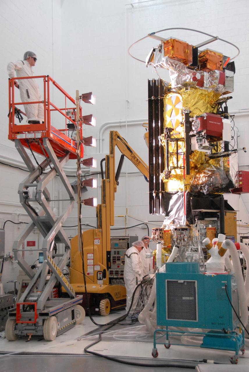 VANDENBERG AIR FORCE BASE, Calif. -- In the NASA payload processing facility at Vandenberg Air Force Base in California, workers conduct solar array illumination on the NOAA-N Prime satellite. NOAA-N Prime is the latest polar-orbiting operational environmental weather satellite developed by NASA for the National Oceanic and Atmospheric Administration. The satellite is scheduled to launch Feb. 4 aboard a Delta II rocket from Vandenberg Air Force Base. Photo credit: NASA/Robert Hargreaves Jr., VAFB