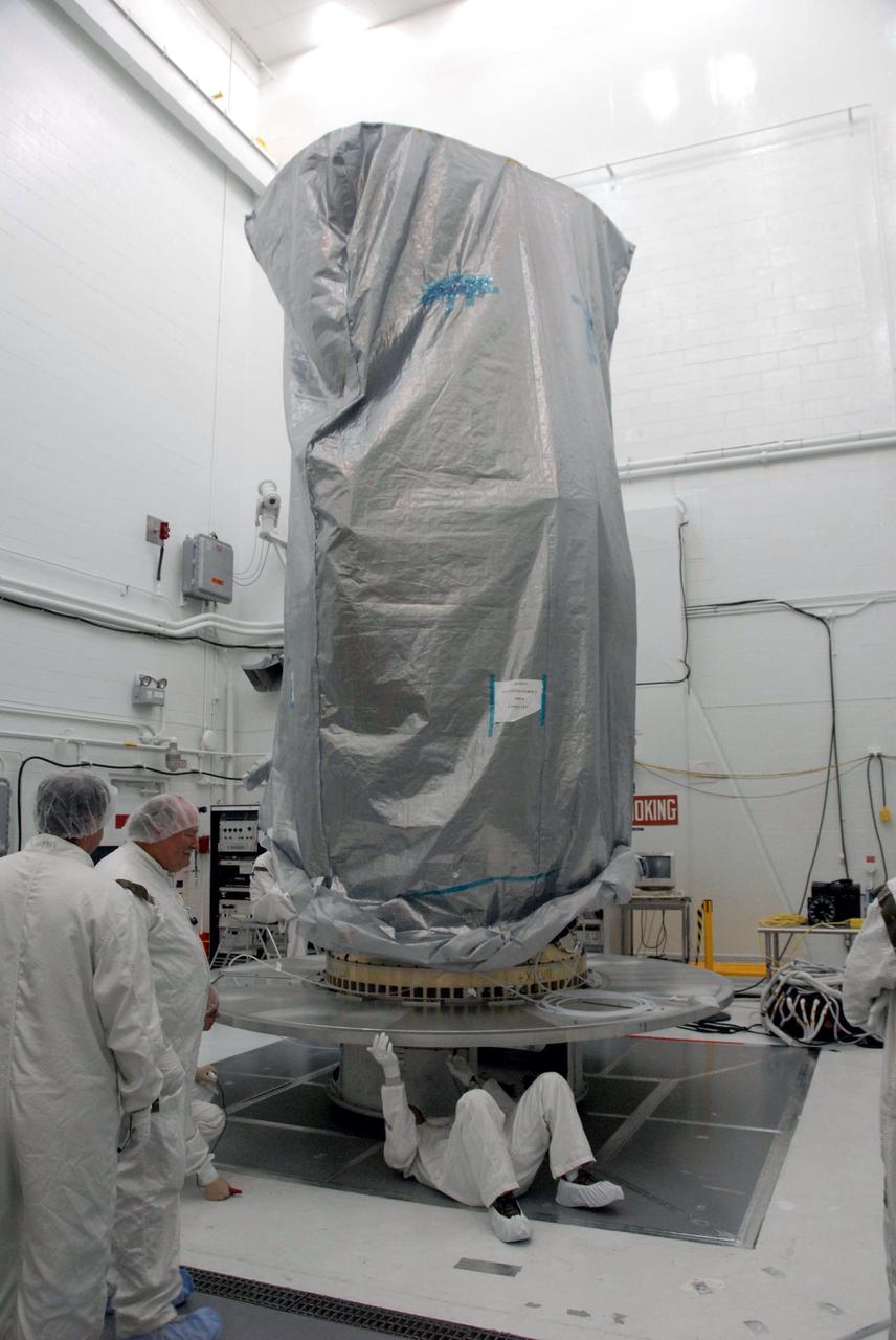 VANDENBERG AIR FORCE BASE, Calif. –  In Building 1610 at Vandenberg Air Force Base in California, the United Launch Alliance direct mate adapter, or DMA, is installed on the NOAA-N Prime's payload attach fitting underneath the spacecraft.  The DMA is needed to install the payload canister around the spacecraft for the journey to the launch pad. NOAA-N Prime is the latest polar-orbiting operational environmental weather satellite developed by NASA for the National Oceanic and Atmospheric Administration. Launch of NOAA-N Prime is scheduled for Feb. 4.  Photo credit: NASA/Doug Kolkow, VAFB