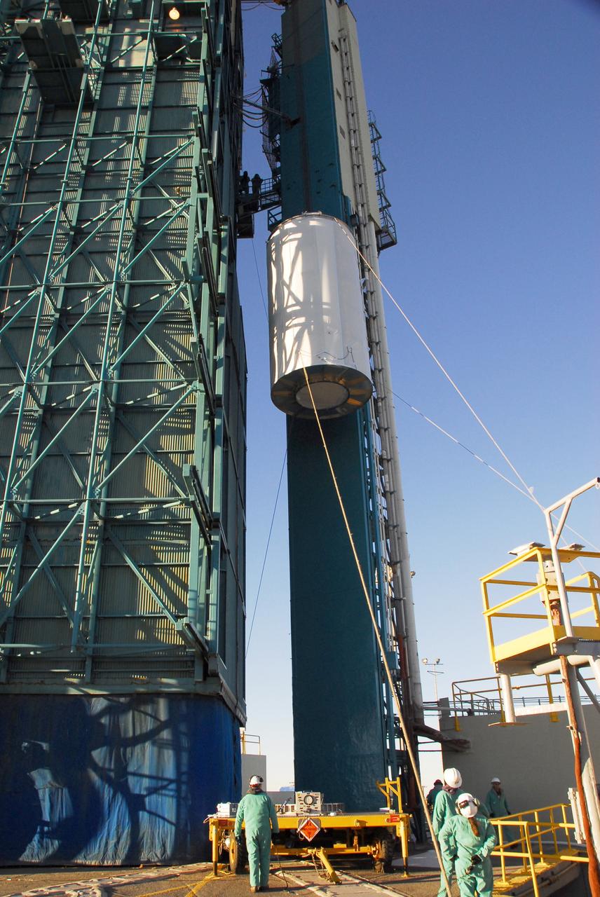 VANDENBERG AIR FORCE BASE, Calif. -- The NOAA-N Prime satellite, enclosed in a canister for travel, is lifted alongside the mobile service tower on Space Launch Complex 2 at Vandenberg Air Force Base in California. In the tower, the satellite will be encapsulated and installed on the launch vehicle, a Delta II rocket. NOAA-N Prime is the latest polar-orbiting operational environmental weather satellite developed by NASA for the National Oceanic and Atmospheric Administration. The satellite is scheduled to launch Feb. 4 aboard a Delta II rocket from Vandenberg Air Force Base. Photo credit: NASA/Mark Mackley, VAFB