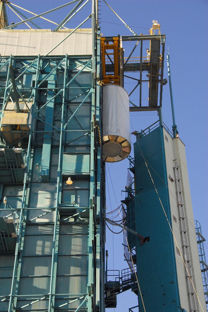 VANDENBERG AIR FORCE BASE, Calif. -- The NOAA-N Prime satellite is lifted to the top of the mobile service tower on Space Launch Complex 2 at Vandenberg Air Force Base in California. In the tower, the satellite will be encapsulated and installed on the launch vehicle, a Delta II rocket. NOAA-N Prime is the latest polar-orbiting operational environmental weather satellite developed by NASA for the National Oceanic and Atmospheric Administration. The satellite is scheduled to launch Feb. 4 aboard a Delta II rocket from Vandenberg Air Force Base. Photo credit: NASA/Mark Mackley, VAFB