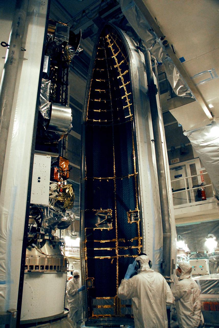 VANDENBERG AIR FORCE BASE, Calif. -- The second half of the fairing is moved into place around the NOAA-N Prime spacecraft in the launch service tower on Space Launch Complex 2 at Vandenberg Air Force Base in California. The fairing is a molded structure that fits flush with the outside surface of the rocket and forms an aerodynamically smooth nose cone, protecting the spacecraft during launch and ascent. NOAA-N Prime is the latest polar-orbiting operational environmental weather satellite developed by NASA for the National Oceanic and Atmospheric Administration. The satellite is scheduled to launch Feb. 4 aboard the Delta II from Vandenberg Air Force Base. Photo credit: NASA/Mark Mackley, VAFB