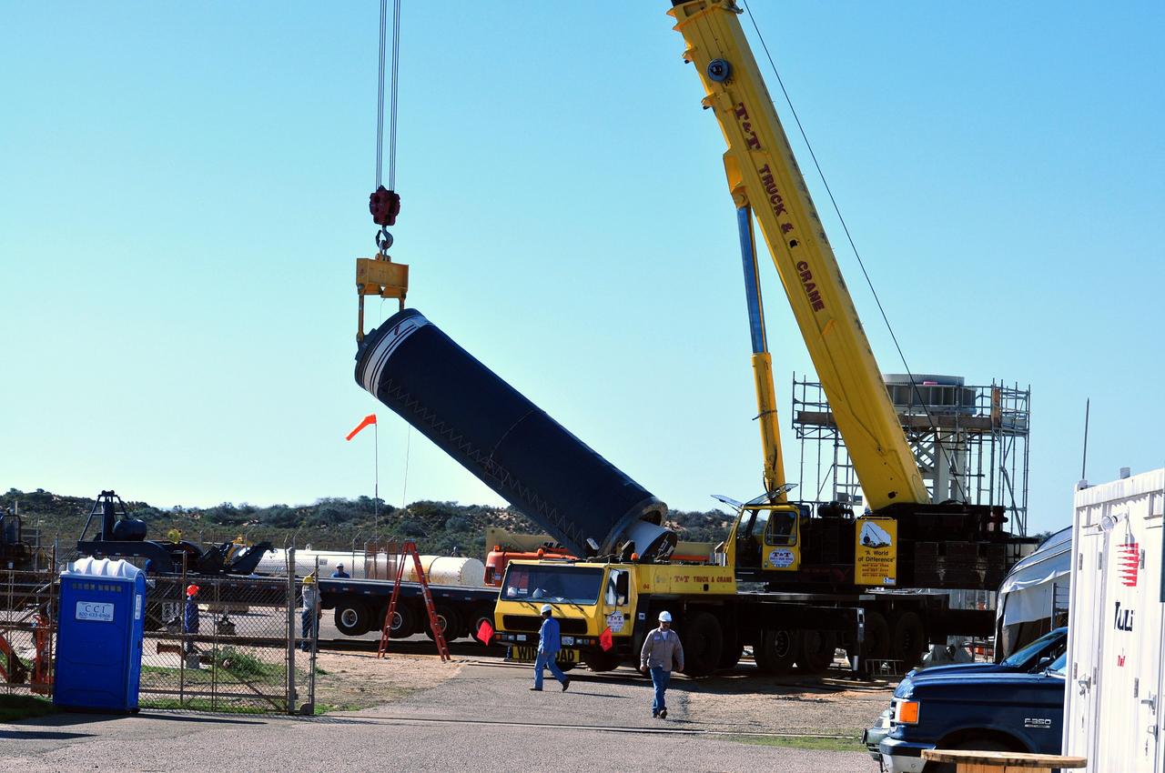 VANDENBERG AIR FORCE BASE, Calif. --  At complex 576E at Vandenberg Air Force Base in California, a crane raises Stage 0 of the Taurus XL launch vehicle for the Orbiting Carbon Observatory from its transporter.  The OCO is a new Earth-orbiting mission sponsored by NASA's Earth System Science Pathfinder Program. It is scheduled to launch Feb. 23. Photo credit: NASA/Randy Beaudoin, VAFB