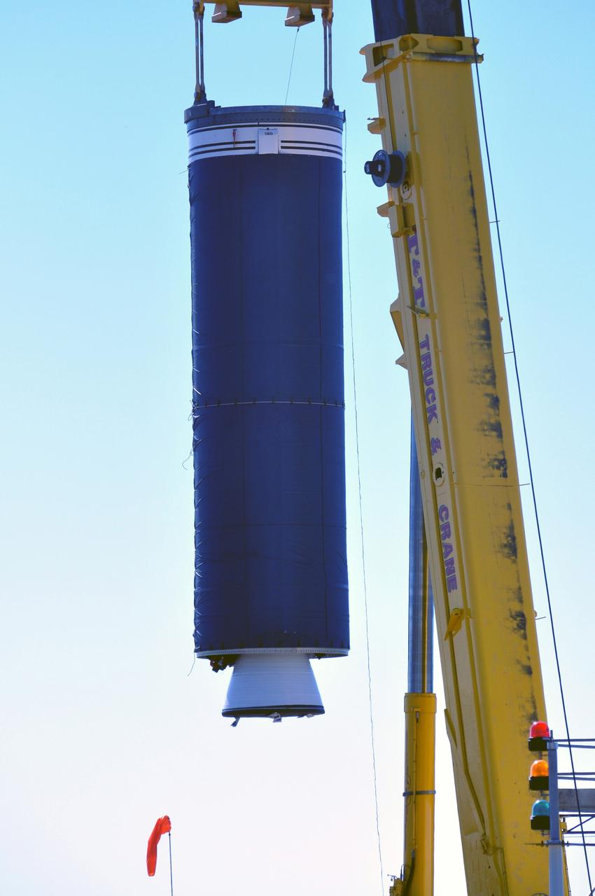 VANDENBERG AIR FORCE BASE, Calif. --   At complex 576E at Vandenberg Air Force Base in California, a crane lifts Stage 0 of the Taurus XL launch vehicle for the Orbiting Carbon Observatory from its transporter. The OCO is a new Earth-orbiting mission sponsored by NASA's Earth System Science Pathfinder Program. It is scheduled to launch Feb. 23. Photo credit: NASA/Randy Beaudoin, VAFB