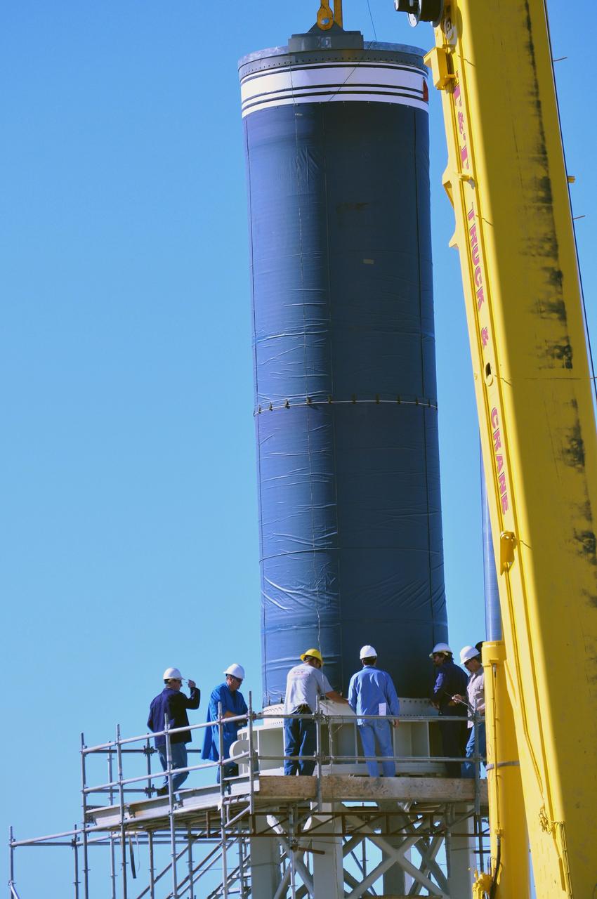 VANDENBERG AIR FORCE BASE, Calif. --  At complex 576E at Vandenberg Air Force Base in California, a crane lifts Stage 0 of the Taurus XL launch vehicle for the Orbiting Carbon Observatory from its transporter. The OCO is a new Earth-orbiting mission sponsored by NASA's Earth System Science Pathfinder Program. It is scheduled to launch Feb. 23. Photo credit: NASA/Randy Beaudoin, VAFB
