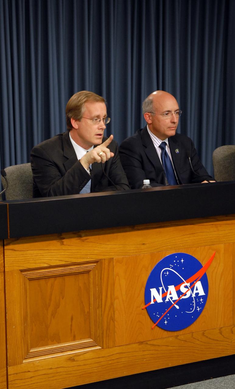 CAPE CANAVERAL, Fla. – At a media conference following the day-long Flight Readiness Review of space shuttle Discovery for the STS-119 mission, NASA's Space Shuttle Program Manager John Shannon responds to a question. On the right is Mike Suffredini, program manager for the International Space Station. NASA managers decided to plan a launch no earlier than Feb. 19, pending additional analysis and particle impact testing associated with a flow control valve in the shuttle's main engine system. Photo credit: NASA/Cory Huston
