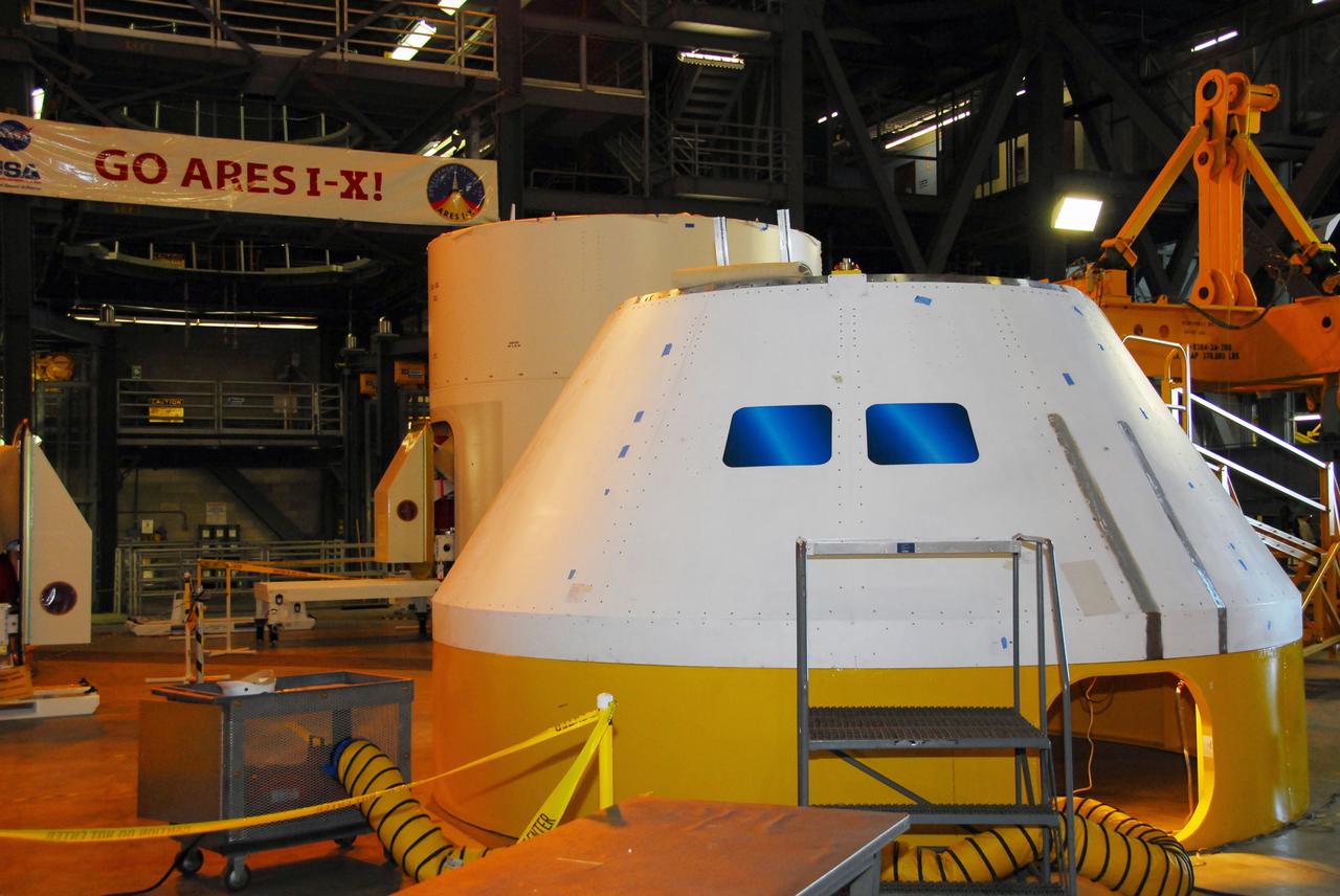 CAPE CANAVERAL, Fla. –   In high bay 4 of the Vehicle Assembly Building at NASA's Kennedy Space Center, the Ares I-X mock-up crew module displays the newly applied window decals.  Ares I-X is the test flight for the Ares I.   The I-X flight will provide NASA an early opportunity to test and prove hardware, facilities and ground operations associated with Ares I. The launch of full-scale Ares I-X, targeted for July 2009, will be the first in a series of unpiloted rocket launches from Kennedy. When fully developed, the 16-foot diameter crew module will furnish living space and reentry protection for the astronauts.  Photo credit: NASA/Tim Jacobs