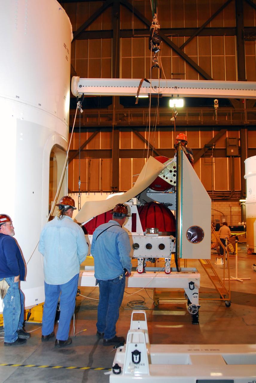 CAPE CANAVERAL, Fla. –  The Ares I-X roll control system module, comprising two modules and four thrusters, is being prepared for a fit check on the Ares I-X rocket upper stage simulator.  The hardware is in high bay 4 of the Vehicle Assembly Building at NASA's Kennedy Space Center.  The system is designed to perform a 90-degree roll after the rocket clears the launch tower, preventing a roll during flight and maintaining the orientation of the rocket until separation of the upper and first stages. The system module will return to earth and splash down; it will not be recovered.  Ares I-X is the test vehicle for the Ares I, which is part of the Constellation Program to return men to the moon and beyond.  Ares I-X is targeted for launch in summer of 2009.  Photo credit: NASA/Tim Jacobs