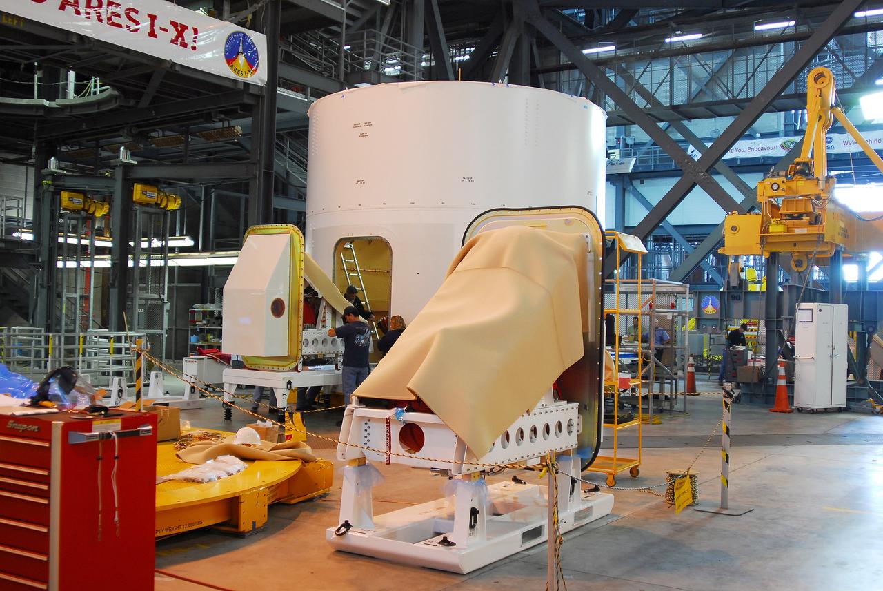 CAPE CANAVERAL, Fla. –  The Ares I-X roll control system module, comprising two modules and four thrusters, is being moved toward the upper stage simulator for a fit check. The hardware is in high bay 4 of the Vehicle Assembly Building at NASA's Kennedy Space Center.  The system is designed to perform a 90-degree roll after the rocket clears the launch tower, preventing a roll during flight and maintaining the orientation of the rocket until separation of the upper and first stages. The system module will return to earth and splash down; it will not be recovered.  Ares I-X is the test vehicle for the Ares I, which is part of the Constellation Program to return men to the moon and beyond.  Ares I-X is targeted for launch in summer of 2009.  Photo credit: NASA/Tim Jacobs