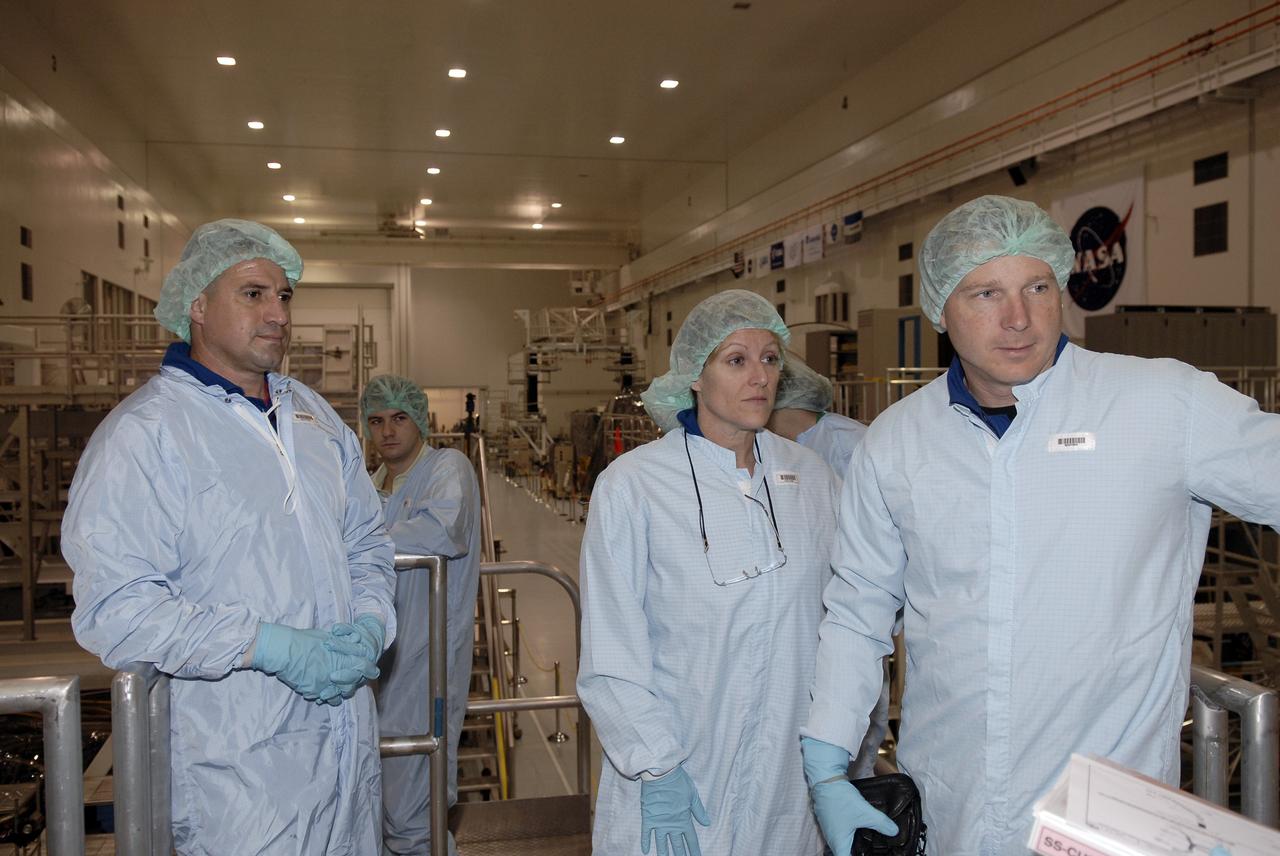 CAPE CANAVERAL, Fla. –  In the Space Station Processing Facility, members of the STS-130 crew look over the Cupola, part of the payload on their mission to the International Space Station. From left in the foreground are Commander George Zamka, Mission Specialist Kathryn Hire and Pilot Terry Virts Jr.  The seven-windowed module will be used as a control room for robotics on the station. Endeavour will also deliver the final connecting node, Node 3.  Photo credit: NASA/Kim Shiflett