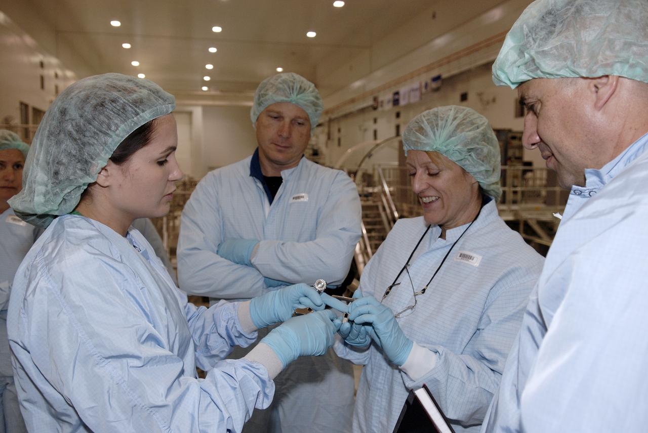 CAPE CANAVERAL, Fla. –  In the Space Station Processing Facility, STS-130 Mission Specialist Kathryn Hire (second from right) gets a close look at hardware associated with the Cupola, part of the payload on the mission to the International Space Station. Next to her are (left) Pilot Terry Virts Jr. and (right) Commander George Zamka.  The seven-windowed module will be used as a control room for robotics on the station. Endeavour will also deliver the final connecting node, Node 3.  Photo credit: NASA/Kim Shiflett