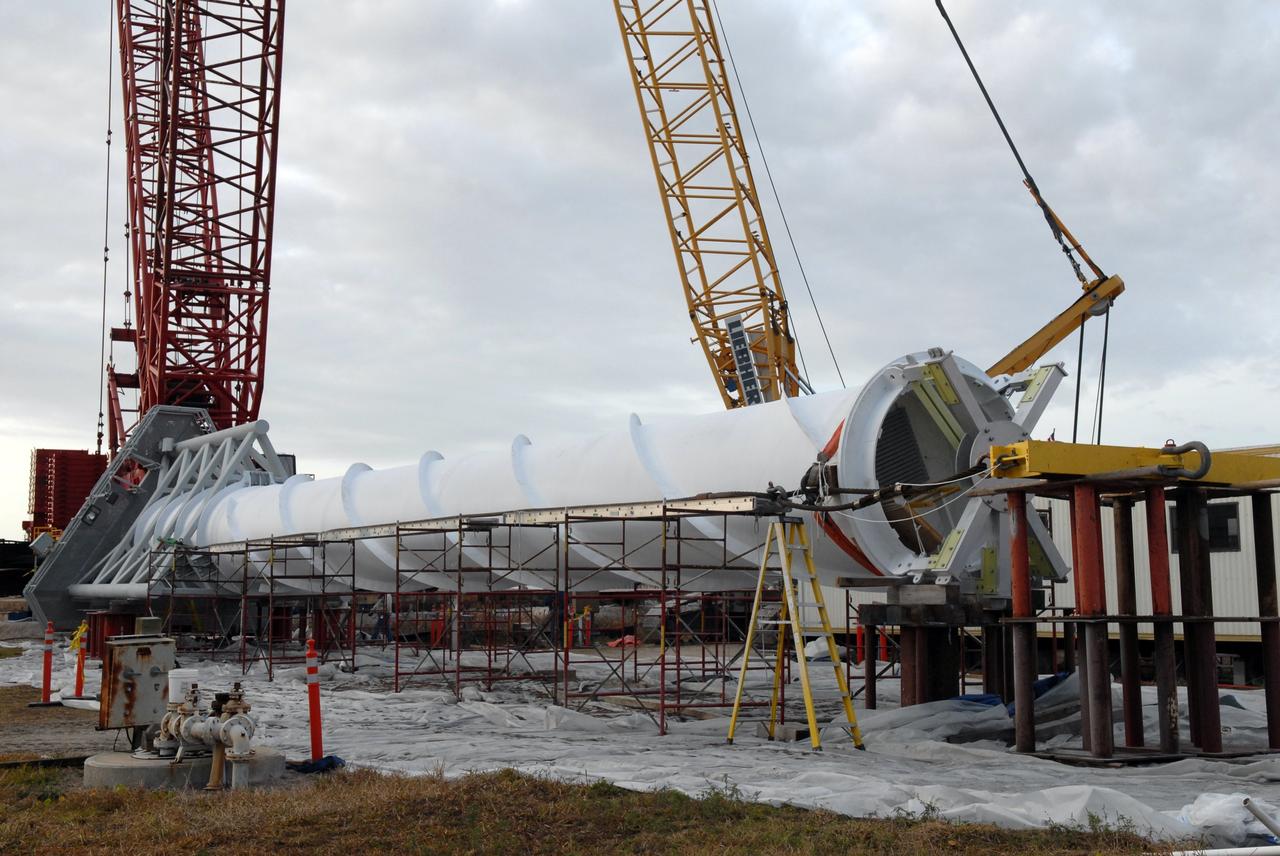 CAPE CANAVERAL, Fla. – A lightning mast remains to be lifted atop the third and final lightning tower erected on Launch Pad 39B at NASA's Kennedy Space Center. Three towers surround the pad.  The new lightning protection system is being built for the Constellation Program and Ares/Orion launches.  Each of the towers is 500 feet tall with an additional 100-foot fiberglass mast atop supporting a wire catenary system.  This improved lightning protection system allows for the taller height of the Ares I rocket compared to the space shuttle.  Pad 39B will be the site of the first Ares vehicle launch, including the Ares I-X test flight that is targeted for July 2009. Photo credit: NASA/Jack Pfaller