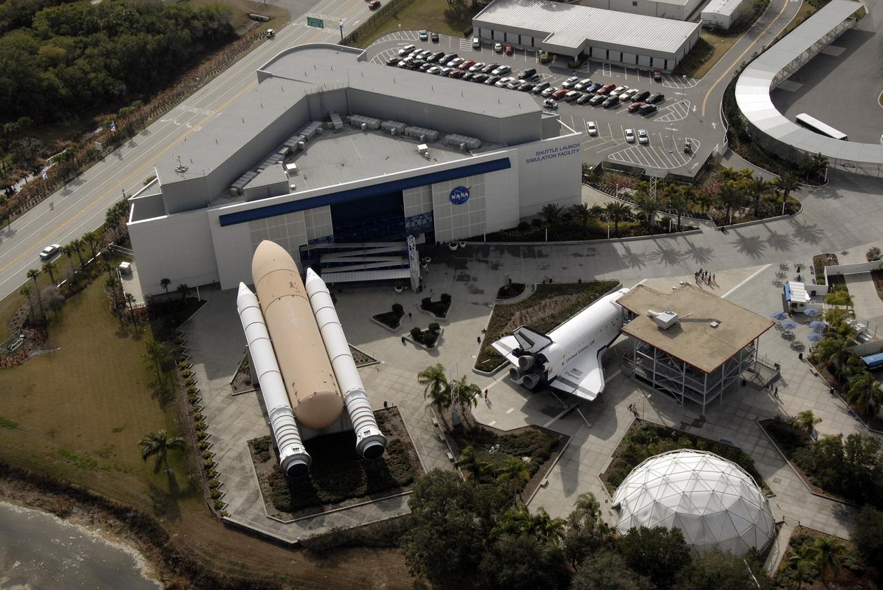 CAPE CANAVERAL, Fla. – An aerial view of part of NASA's Kennedy Space Center Visitor Complex in Florida. A full-size orbiter replica (at right), the "Explorer," allows guests to picture more clearly what it's like to live and work in space. Full-size, genuine solid rocket boosters and an external fuel tank are also on display, representing all three components of a space shuttle. Photo credit: NASA/Kim Shiflett