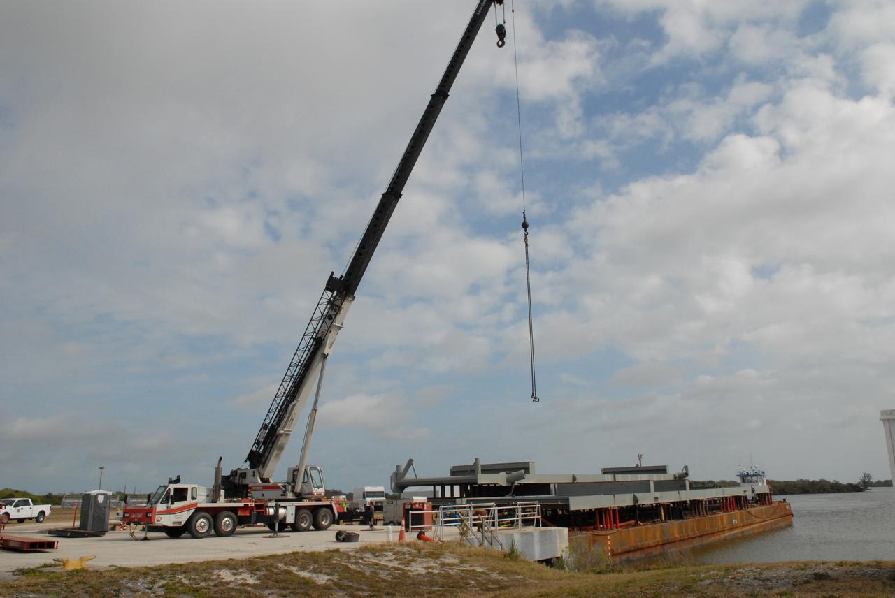 CAPE CANAVERAL, Fla. – A girder for a new mobile launcher is ready for offloading at the turn basin in the Launch Complex 39 Area of NASA's Kennedy Space Center in Florida.  The new mobile launcher will be the base for the Ares rockets to launch the Orion crew exploration vehicle and the cargo vehicle.  The base is being made lighter than space shuttle mobile launcher platforms so the crawler-transporter can pick up the added load of the 345-foot tower and taller rocket.  When the structural portion of the new mobile launcher is complete, umbilicals, access arms, communications equipment and command/control equipment will be installed. Photo credit: NASA/Jack Pfaller