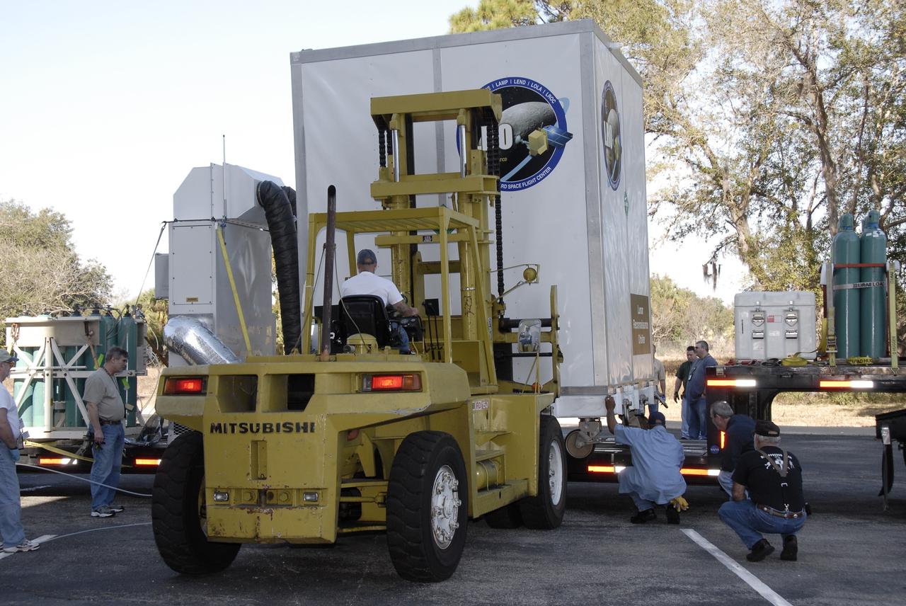 CAPE CANAVERAL, Fla. – NASA's Lunar Reconnaissance Orbiter, or LRO, spacecraft is offloaded from the truck at Astrotech Space Operations in Titusville, Fla.  The spacecraft was built by engineers at Goddard Space Flight Center, where it recently completed two months of tests in a thermal vacuum chamber. The orbiter will carry seven instruments to provide scientists with detailed maps of the lunar surface and enhance our understanding of the moon's topography, lighting conditions, mineralogical composition and natural resources. Information gleaned from LRO will be used to select safe landing sites, determine locations for future lunar outposts and help mitigate radiation dangers to astronauts. The polar regions of the moon are the main focus of the mission because continuous access to sunlight may be possible and water ice may exist in permanently shadowed areas of the poles.  Accompanying LRO on its journey to the moon will be the Lunar Crater Observation and Sensing Satellite, or LCROSS, a mission that will impact the lunar surface in its search for water ice.  Launch of LRO is targeted for April 24.  Photo credit: NASA/Kim Shiflett