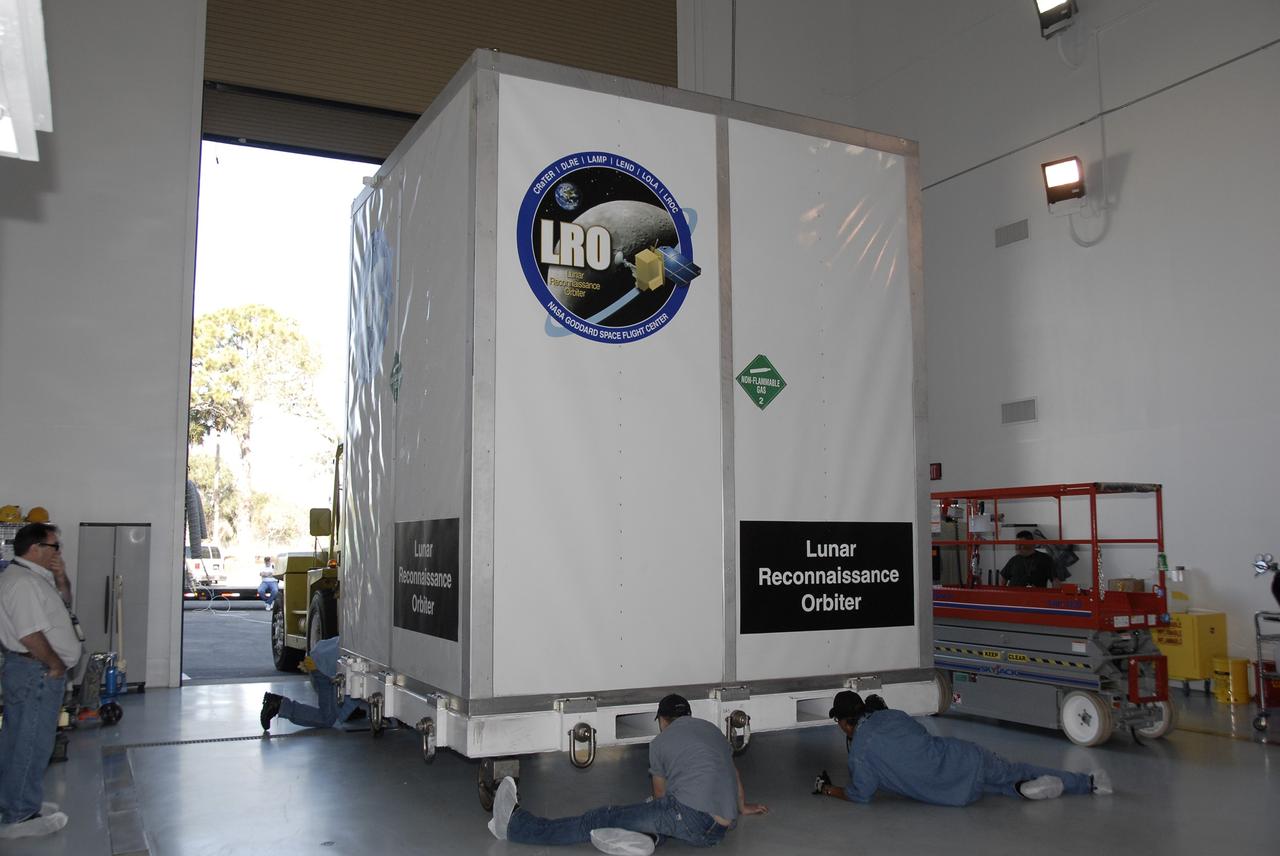 CAPE CANAVERAL, Fla. – NASA's Lunar Reconnaissance Orbiter, or LRO, spacecraft is moved into Astrotech in Titusville, Fla. The spacecraft was built by engineers at Goddard Space Flight Center, where it recently completed two months of tests in a thermal vacuum chamber. The orbiter will carry seven instruments to provide scientists with detailed maps of the lunar surface and enhance our understanding of the moon's topography, lighting conditions, mineralogical composition and natural resources. Information gleaned from LRO will be used to select safe landing sites, determine locations for future lunar outposts and help mitigate radiation dangers to astronauts. The polar regions of the moon are the main focus of the mission because continuous access to sunlight may be possible and water ice may exist in permanently shadowed areas of the poles. Accompanying LRO on its journey to the moon will be the Lunar Crater Observation and Sensing Satellite, or LCROSS, a mission that will impact the lunar surface in its search for water ice. Launch of LRO is targeted for April 24. Photo credit: NASA/Kim Shiflett