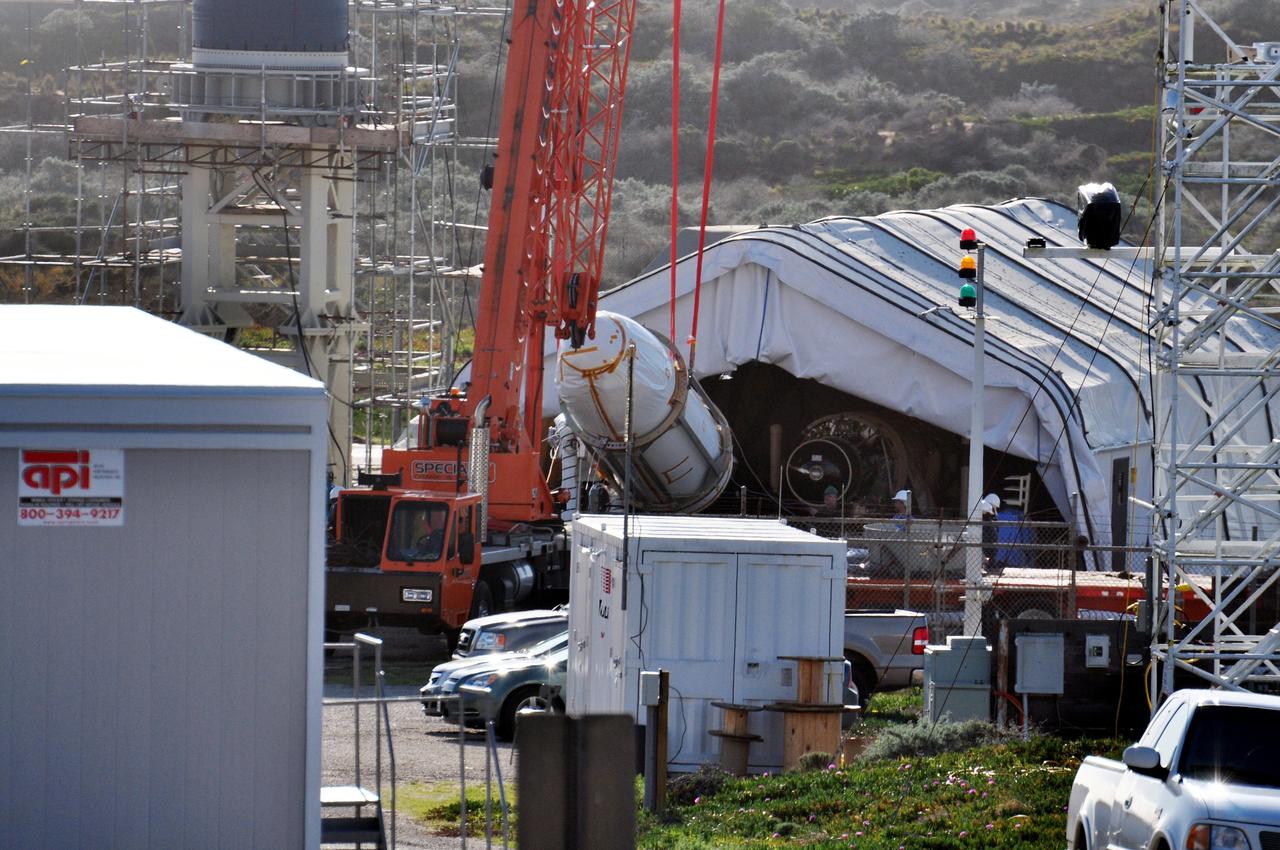 VANDENBERG AIR FORCE BASE, Calif. --The Encapsulated Cargo Element (ECE) containing NASA's Orbiting Carbon Observatory, or OCO, is lowered to a horizontal position after arrival at Space Launch Complex 576-E at Vandenberg Air Force Base in California.   The spacecraft is scheduled for launch aboard Orbital Sciences' Taurus XL rocket on Feb. 23 from Vandenberg.  The spacecraft will collect precise global measurements of carbon dioxide (CO2) in the Earth's atmosphere. Scientists will analyze OCO data to improve our understanding of the natural processes and human activities that regulate the abundance and distribution of this important greenhouse gas. This improved understanding will enable more reliable forecasts of future changes in the abundance and distribution of CO2 in the atmosphere and the effect that these changes may have on the Earth's climate.  Photo credit: NASA/Randy Beaudoin, VAFB