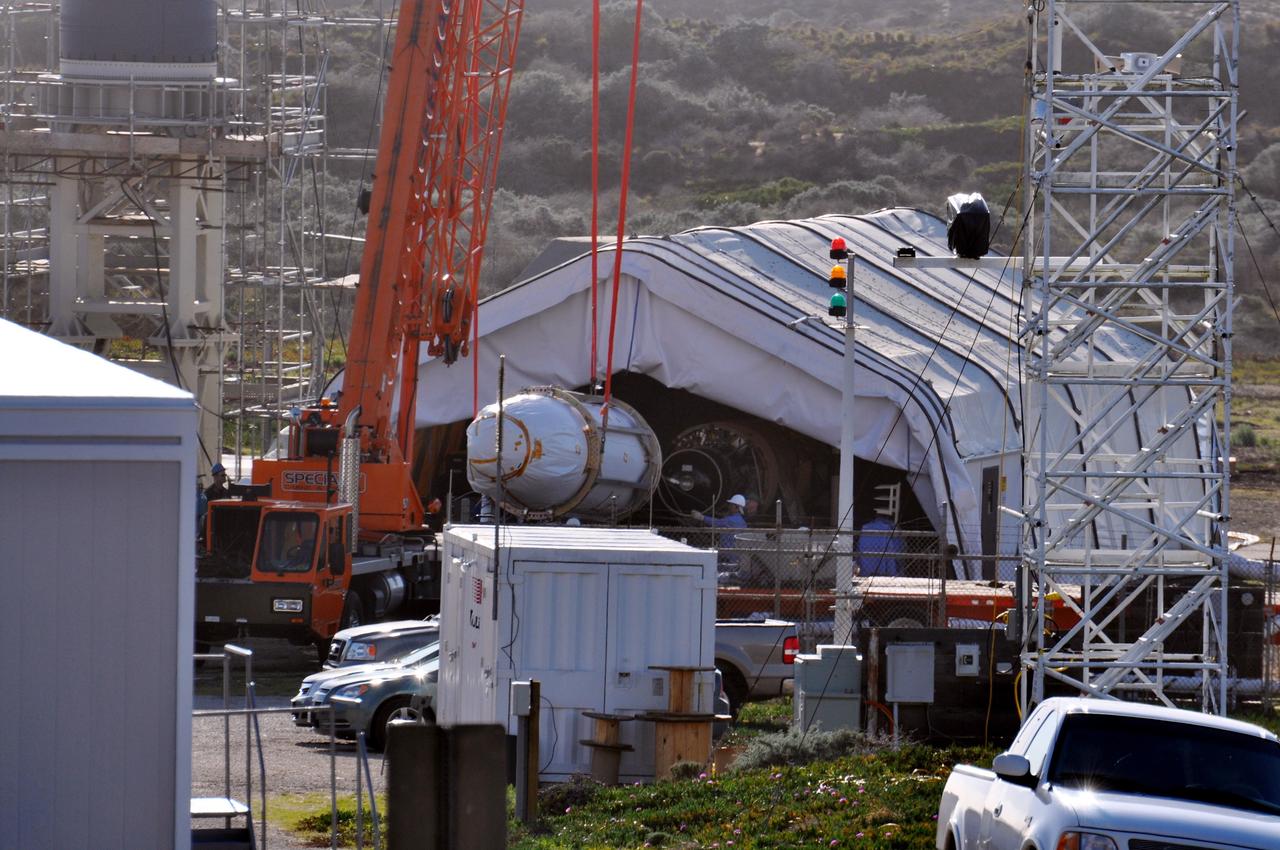 VANDENBERG AIR FORCE BASE, Calif. -- The Encapsulated Cargo Element (ECE) containing NASA's Orbiting Carbon Observatory, or OCO, is lowered to a horizontal position after arrival at Space Launch Complex 576-E at Vandenberg Air Force Base in California.  The spacecraft is scheduled for launch aboard Orbital Sciences' Taurus XL rocket on Feb. 23 from Vandenberg. The spacecraft will collect precise global measurements of carbon dioxide (CO2) in the Earth's atmosphere. Scientists will analyze OCO data to improve our understanding of the natural processes and human activities that regulate the abundance and distribution of this important greenhouse gas. This improved understanding will enable more reliable forecasts of future changes in the abundance and distribution of CO2 in the atmosphere and the effect that these changes may have on the Earth's climate.  Photo credit: NASA/Randy Beaudoin, VAFB