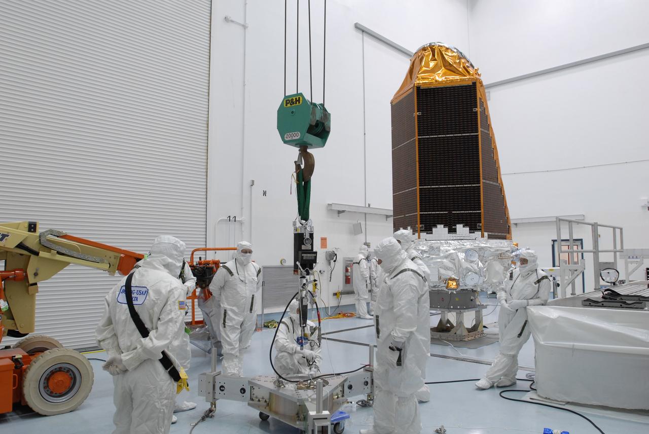CAPE CANAVERAL, Fla. – At the Hazardous Processing Facility at Astrotech in Titusville, Fla., workers prepare the scale that will be used to weigh the Kepler spacecraft, in the background. Kepler is designed to survey more than 100,000 stars in our galaxy to determine the number of sun-like stars that have Earth-size and larger planets, including those that lie in a star's "habitable zone," a region where liquid water, and perhaps life, could exist. If these Earth-size worlds do exist around stars like our sun, Kepler is expected to be the first to find them and the first to measure how common they are. The liftoff of Kepler aboard a Delta II rocket is currently targeted for 10:48 p.m. EST March 5 from Space Launch Complex 17 on Cape Canaveral Air Force Station. Photo credit: NASA/Jim Grossmann