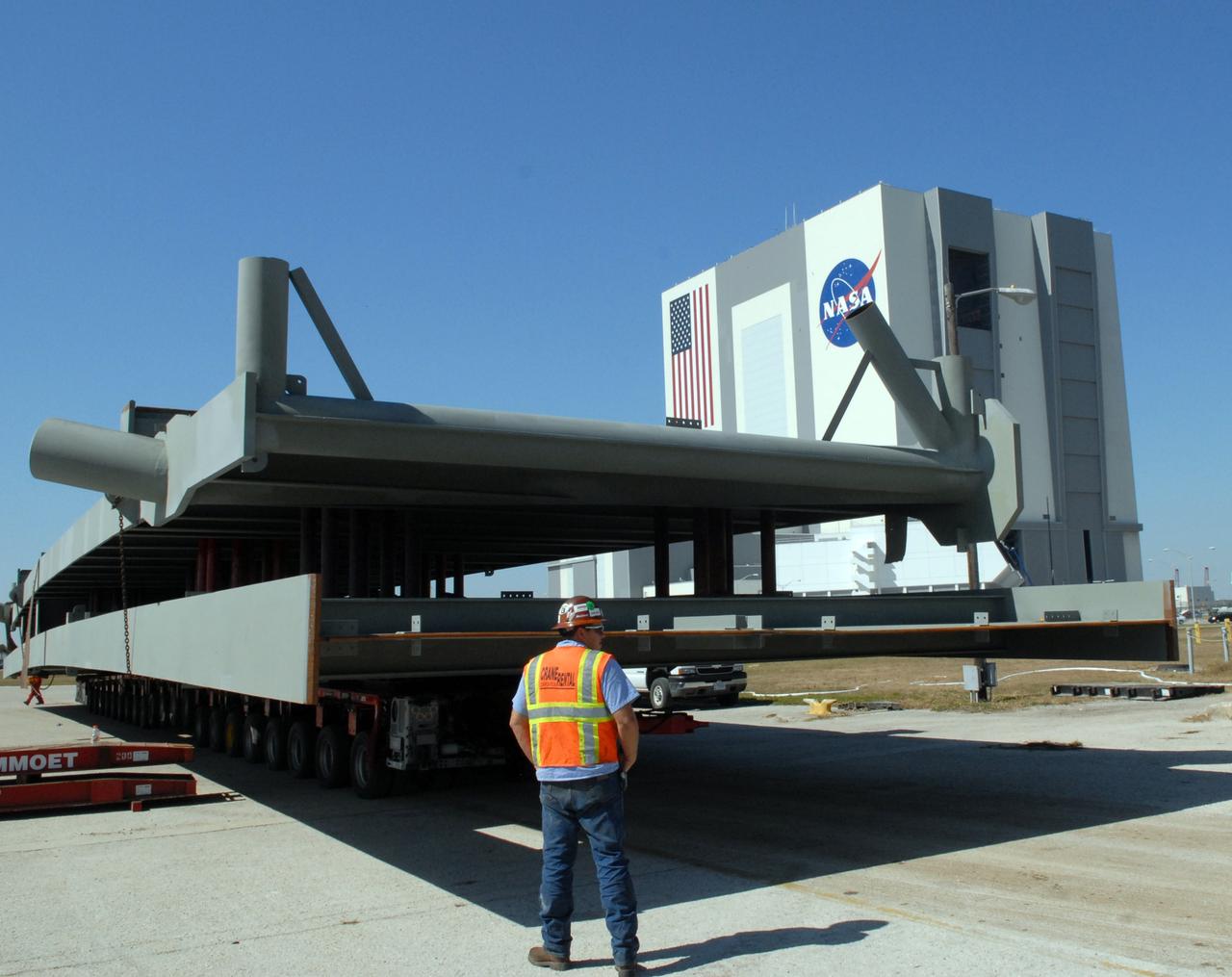 CAPE CANAVERAL, Fla. – At the turn basin at NASA's Kennedy Space Center in Florida, the girder for the new mobile launcher is moved from the barge onto the loading area.  The new mobile launcher will be the base for the Ares rockets to launch the Orion crew exploration vehicle and the cargo vehicle.  The base is being made lighter than space shuttle mobile launcher platforms so the crawler-transporter can pick up the added load of the 345-foot tower and taller rocket.  When the structural portion of the new mobile launcher is complete, umbilicals, access arms, communications equipment and command/control equipment will be installed.  Photo credit: NASA/Jack Pfaller