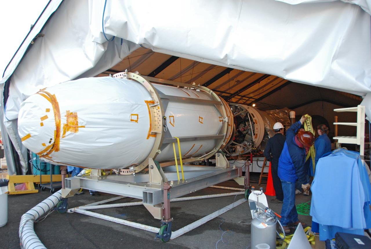 VANDENBERG AIR FORCE BASE, Calif. -- On Space Launch Complex 576-E at Vandenberg Air Force Base in California, the encapsulated cargo element containing NASA’s Orbiting Carbon Observatory, or OCO, enters the tent for integration with Orbital Sciences’ Taurus XL launch vehicle, at right.   The OCO is an Earth-orbiting mission sponsored by NASA's Earth System Science Pathfinder Program. The observatory will collect precise global measurements of carbon dioxide in the Earth's atmosphere. Scientists will analyze the data returned to better understand the natural processes and human activities that regulate the abundance and distribution of this important greenhouse gas.  Launch is targeted for Feb. 24 from Space Launch Complex 576-E at Vandenberg.  Photo credit: VAFB/Wayne North