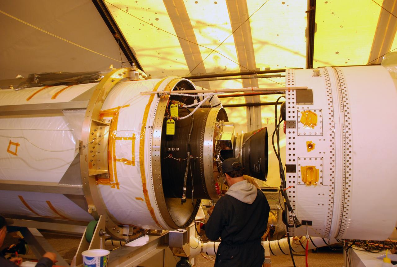 VANDENBERG AIR FORCE BASE, Calif. -- On Space Launch Complex 576-E at Vandenberg Air Force Base in California, an Orbital Sciences technician connects ground wires to the Stage 3 motor of the Taurus XL launch vehicle for NASA’s Orbiting Carbon Observatory, or OCO. The encapsulated cargo element containing the observatory is integrated with the vehicle.   The OCO is an Earth-orbiting mission sponsored by NASA's Earth System Science Pathfinder Program. The observatory will collect precise global measurements of carbon dioxide in the Earth's atmosphere. Scientists will analyze the data returned to better understand the natural processes and human activities that regulate the abundance and distribution of this important greenhouse gas.  Launch is targeted for Feb. 24 from Space Launch Complex 576-E at Vandenberg.  Photo credit: VAFB/Wayne North
