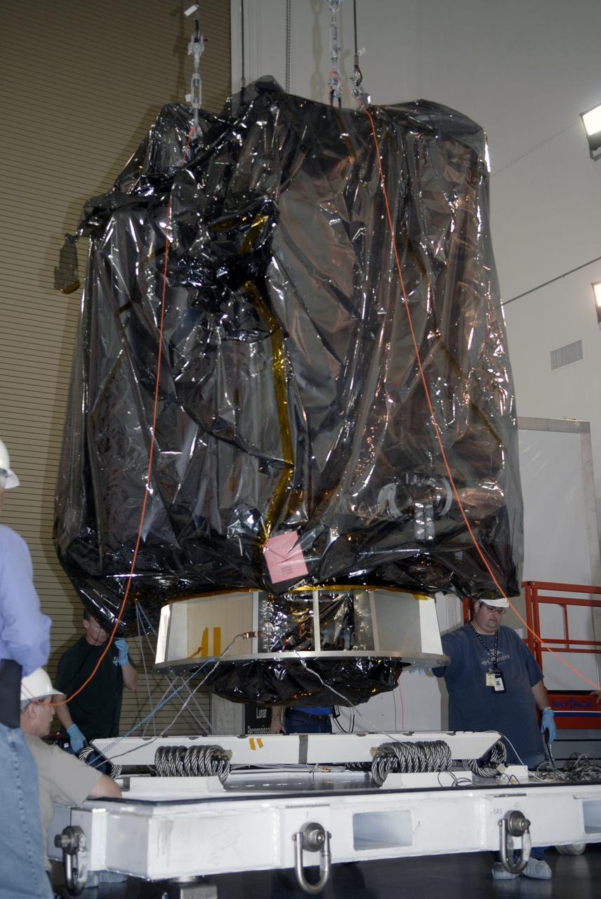 CAPE CANAVERAL, Fla. – Technicians guide NASA's Lunar Reconnaissance Orbiter, or LRO, as it is lifted from a transportation pallet at the Astrotech processing facility in Titusville, Fla. The spacecraft was built by engineers at Goddard Space Flight Center, where it recently completed two months of tests in a thermal vacuum chamber. The orbiter will carry seven instruments to provide scientists with detailed maps of the lunar surface and enhance our understanding of the moon's topography, lighting conditions, mineralogical composition and natural resources. Information gleaned from LRO will be used to select safe landing sites, determine locations for future lunar outposts and help mitigate radiation dangers to astronauts. The polar regions of the moon are the main focus of the mission because continuous access to sunlight may be possible and water ice may exist in permanently shadowed areas of the poles. Accompanying LRO on its journey to the moon will be the Lunar Crater Observation and Sensing Satellite, or LCROSS, a mission that will impact the lunar surface in its search for water ice. Launch of LRO/LCROSS is targeted for April 24. Photo credit: NASA/Kim Shiflett