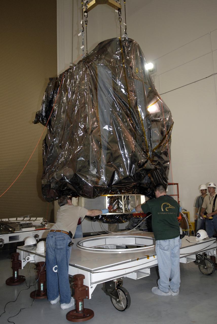 CAPE CANAVERAL, Fla. – Technicians guide NASA's Lunar Reconnaissance Orbiter, or LRO, onto a work stand in the high bay at the Astrotech processing facility in Titusville, Fla. The spacecraft was built by engineers at Goddard Space Flight Center, where it recently completed two months of tests in a thermal vacuum chamber. The orbiter will carry seven instruments to provide scientists with detailed maps of the lunar surface and enhance our understanding of the moon's topography, lighting conditions, mineralogical composition and natural resources. Information gleaned from LRO will be used to select safe landing sites, determine locations for future lunar outposts and help mitigate radiation dangers to astronauts. The polar regions of the moon are the main focus of the mission because continuous access to sunlight may be possible and water ice may exist in permanently shadowed areas of the poles. Accompanying LRO on its journey to the moon will be the Lunar Crater Observation and Sensing Satellite, or LCROSS, a mission that will impact the lunar surface in its search for water ice. Launch of LRO/LCROSS is targeted for April 24. Photo credit: NASA/Kim Shiflett