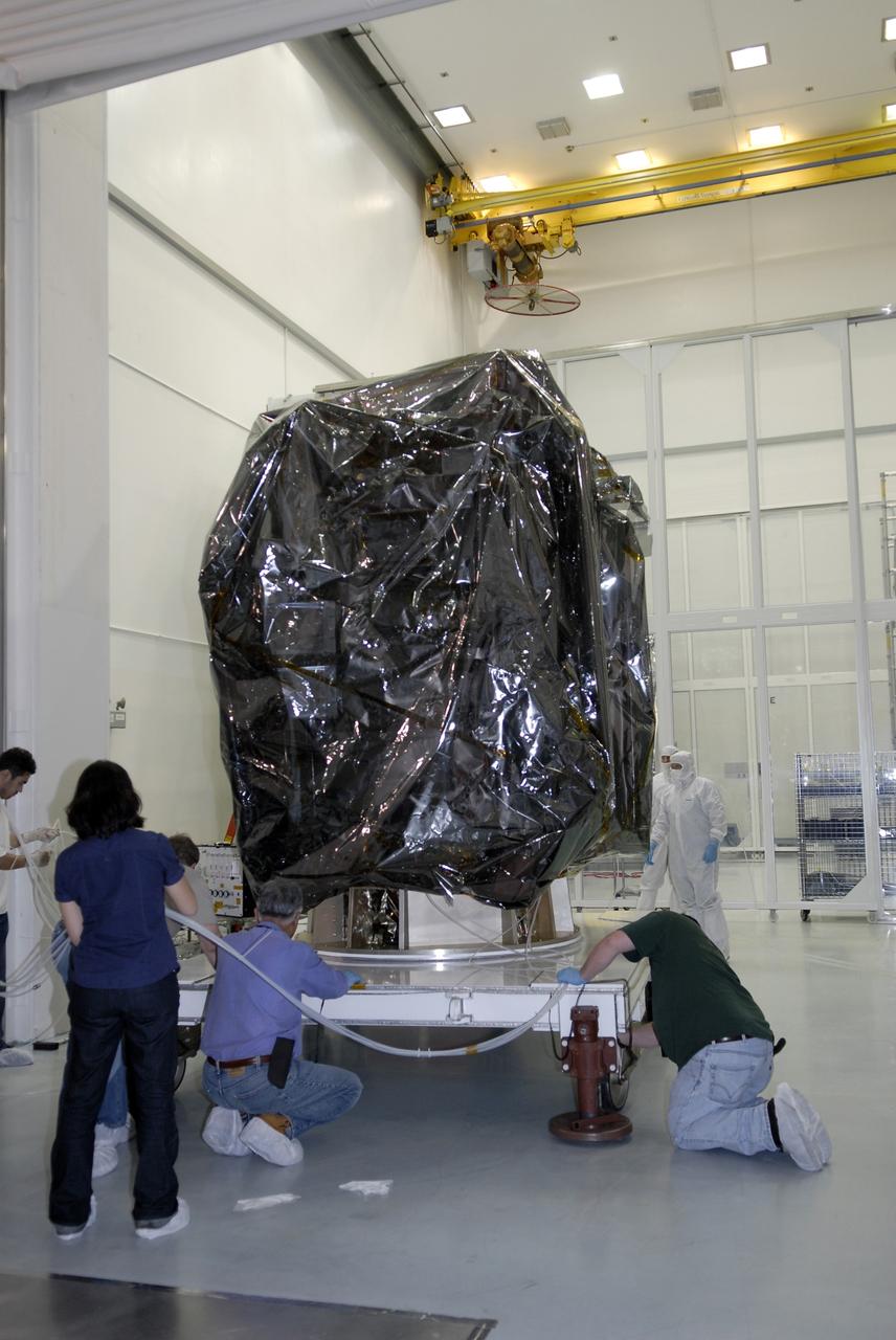 CAPE CANAVERAL, Fla. – Technicians secure a work stand supporting NASA's Lunar Reconnaissance Orbiter, or LRO, in the high bay at the Astrotech processing facility in Titusville, Fla. The spacecraft was built by engineers at Goddard Space Flight Center, where it recently completed two months of tests in a thermal vacuum chamber. The orbiter will carry seven instruments to provide scientists with detailed maps of the lunar surface and enhance our understanding of the moon's topography, lighting conditions, mineralogical composition and natural resources. Information gleaned from LRO will be used to select safe landing sites, determine locations for future lunar outposts and help mitigate radiation dangers to astronauts. The polar regions of the moon are the main focus of the mission because continuous access to sunlight may be possible and water ice may exist in permanently shadowed areas of the poles. Accompanying LRO on its journey to the moon will be the Lunar Crater Observation and Sensing Satellite, or LCROSS, a mission that will impact the lunar surface in its search for water ice. Launch of LRO/LCROSS is targeted for April 24. Photo credit: NASA/Kim Shiflett
