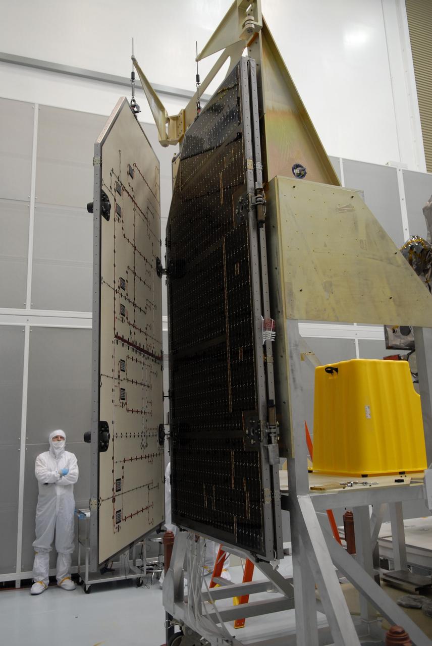 CAPE CANAVERAL, Fla. – A technician inspects the solar arrays for NASA's Lunar Reconnaissance Orbiter, or LRO, at the Astrotech processing facility in Titusville, Fla.  The spacecraft was built by engineers at Goddard Space Flight Center, where it recently completed two months of tests in a thermal vacuum chamber. The orbiter will carry seven instruments to provide scientists with detailed maps of the lunar surface and enhance our understanding of the moon's topography, lighting conditions, mineralogical composition and natural resources. Information gleaned from LRO will be used to select safe landing sites, determine locations for future lunar outposts and help mitigate radiation dangers to astronauts. The polar regions of the moon are the main focus of the mission because continuous access to sunlight may be possible and water ice may exist in permanently shadowed areas of the poles. Accompanying LRO on its journey to the moon will be the Lunar Crater Observation and Sensing Satellite, or LCROSS, a mission that will impact the lunar surface in its search for water ice. Launch of LRO/LCROSS is targeted for April 24.     Photo credit: NASA/Jack Pfaller