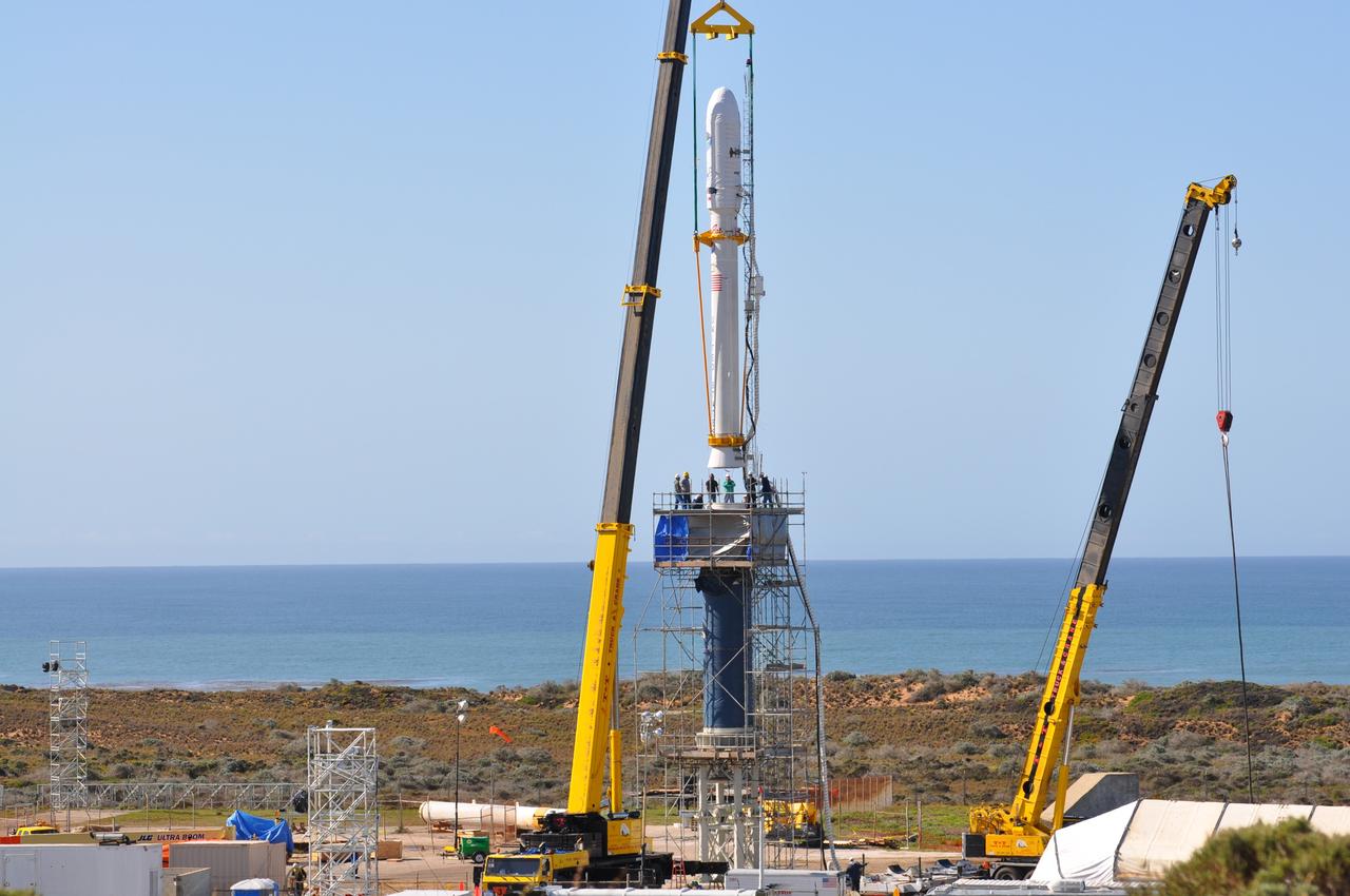 VANDENBERG AIR FORCE BASE, Calif. -- On Launch Complex 576-E at Vandenberg Air Force Base in California, NASA's Orbiting Carbon Observatory, OCO, upper stack is lowered toward the Stage 0 motor of the Taurus XL vehicle. The upper stack consists of Stages 1, 2 and 3 of the Taurus. The spacecraft is scheduled for launch aboard Orbital Sciences' Taurus XL rocket Feb. 24 from Vandenberg. The spacecraft will collect precise global measurements of carbon dioxide (CO2) in the Earth's atmosphere. Scientists will analyze OCO data to improve our understanding of the natural processes and human activities that regulate the abundance and distribution of this important greenhouse gas.   Photo credit: NASA/Randy Beaudoin, VAFB