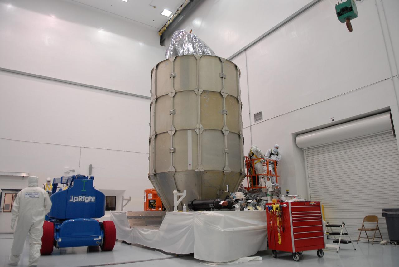 CAPE CANAVERAL, Fla. – At the Astrotech payload processing facility in Titusville, Fla., four levels of canister segments have been installed around NASA's Kepler spacecraft. The "canning" provides protection during the spacecraft's transport to the pad. The liftoff of Kepler aboard a Delta II rocket is currently targeted for 10:48 p.m. EST March 5 from Pad 17-B. Kepler is designed to survey more than 100,000 stars in our galaxy to determine the number of sun-like stars that have Earth-size and larger planets, including those that lie in a star's "habitable zone," a region where liquid water, and perhaps life, could exist. If these Earth-size worlds do exist around stars like our sun, Kepler is expected to be the first to find them and the first to measure how common they are. Photo credit: NASA/Troy Cryder