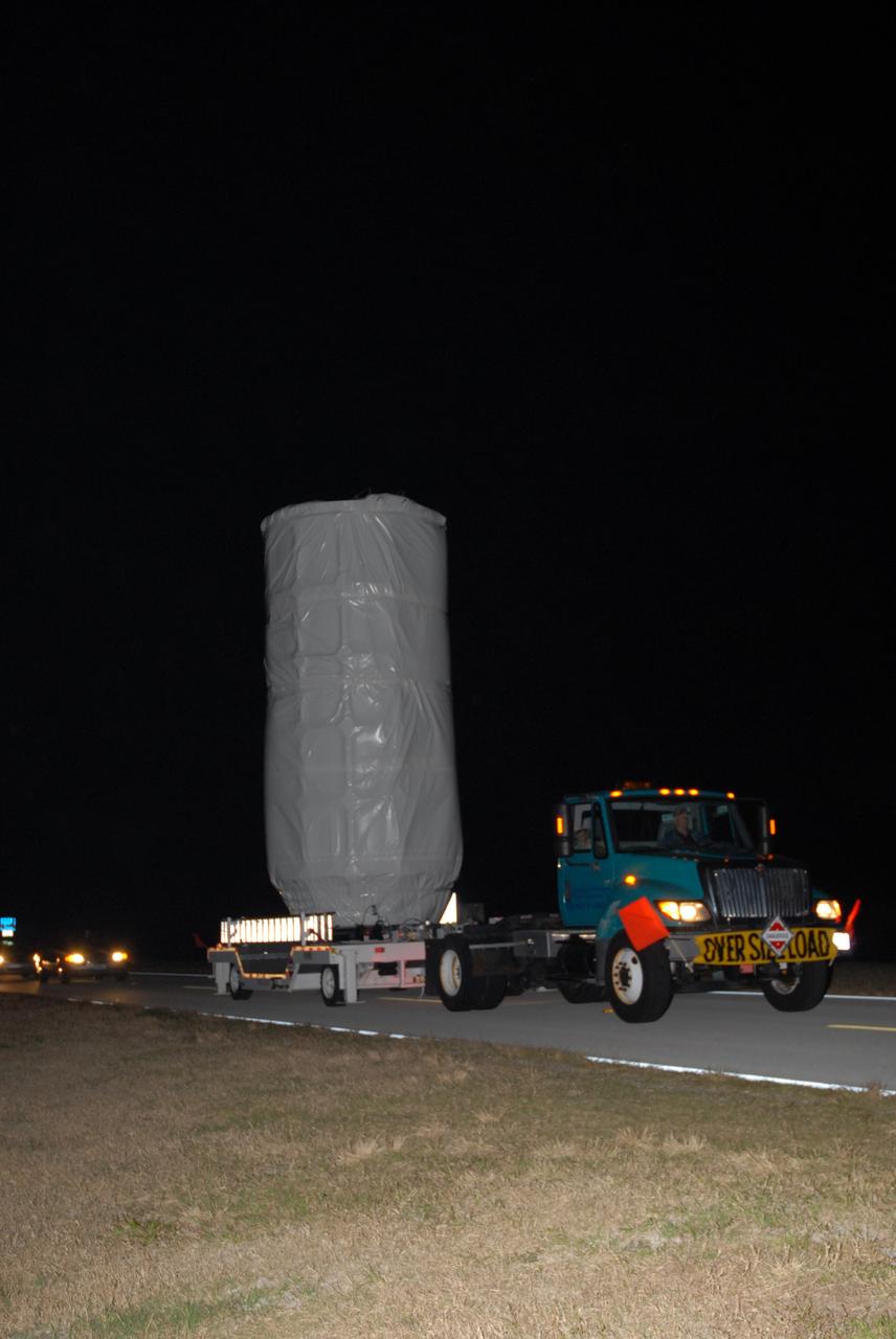CAPE CANAVERAL, Fla. – NASA's Kepler spacecraft, enclosed in a canister and protective cover, travels by truck to Launch Pad 17-B at Cape Canaveral Air Force Station. The liftoff of Kepler aboard a Delta II rocket is currently targeted for 10:48 p.m. EST March 5 from Pad 17-B. Kepler is designed to survey more than 100,000 stars in our galaxy to determine the number of sun-like stars that have Earth-size and larger planets, including those that lie in a star's "habitable zone," a region where liquid water, and perhaps life, could exist. If these Earth-size worlds do exist around stars like our sun, Kepler is expected to be the first to find them and the first to measure how common they are. Photo credit: NASA/Jack Pfaller