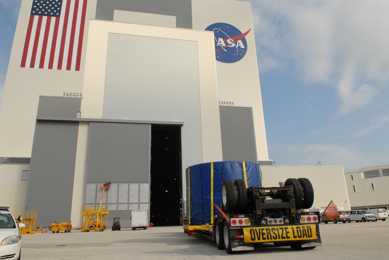 CAPE CANAVERAL, Fla. – The covered fifth segment simulator center for the Ares I-X rocket arrives at the Vehicle Assembly Building at NASA's Kennedy Space Center in Florida. It will join other segments being stacked there. Ares I-X is the test vehicle for the Ares I, which is part of the Constellation Program to return men to the moon and beyond. Ares I is the essential core of a safe, reliable, cost-effective space transportation system that eventually will carry crewed missions back to the moon, on to Mars and out into the solar system. Ares I-X is targeted for launch in July 2009. Photo credit: NASA/Troy Cryder
