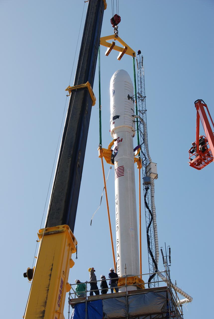 VANDENBERG AIR FORCE BASE, Calif. --  On Launch Complex 576-E at Vandenberg Air Force Base in California, the cables from the crane overhead are removed from NASA's Orbiting Carbon Observatory, OCO, upper stack.  The upper stack was lowered onto the Stage 0 motor of Orbital Sciences' Taurus XL vehicle. The upper stack consists of Stages 1, 2 and 3 of the Taurus, as well as the encapsulated OCO spacecraft. OCO is scheduled for launch the Taurus rocket Feb. 24 from Vandenberg. The spacecraft will collect precise global measurements of carbon dioxide (CO2) in the Earth's atmosphere. Scientists will analyze OCO data to improve our understanding of the natural processes and human activities that regulate the abundance and distribution of this important greenhouse gas. Photo credit: NASA/Richard Nielsen, VAFB