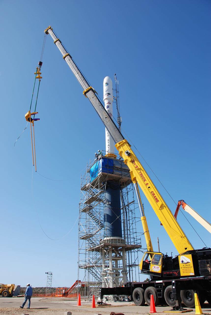 VANDENBERG AIR FORCE BASE, Calif. --  On Launch Complex 576-E at Vandenberg Air Force Base in California, the crane in the foreground moves the cables used to lower NASA's Orbiting Carbon Observatory, OCO, upper stack onto to the Taurus XL Stage 0 motor behind it.  The upper stack consists of Stages 1, 2 and 3 of the Taurus, as well as the encapsulated OCO spacecraft. OCO is scheduled for launch the Taurus rocket Feb. 24 from Vandenberg. The spacecraft will collect precise global measurements of carbon dioxide (CO2) in the Earth's atmosphere. Scientists will analyze OCO data to improve our understanding of the natural processes and human activities that regulate the abundance and distribution of this important greenhouse gas. Photo credit: NASA/Richard Nielsen, VAFB