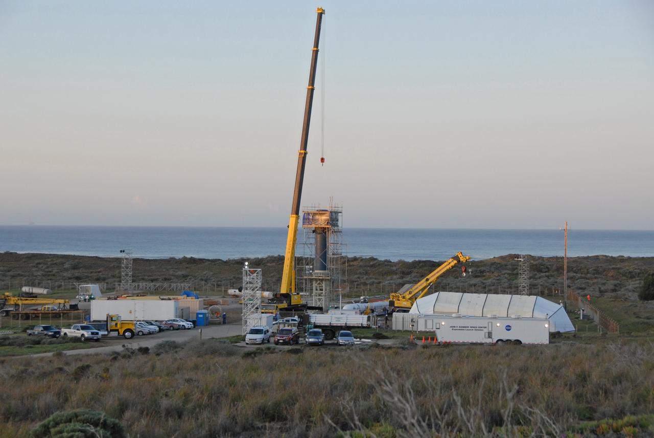 VANDENBERG AIR FORCE BASE, Calif. --  On Launch Complex 576-E at Vandenberg Air Force Base in California, NASA's Orbiting Carbon Observatory, or OCO, upper stack is prepared to be raised to vertical. The upper stack, consists of Stages 1, 2 and 3 of Orbital Sciences' Taurus XL rocket as well as the encapsulated OCO spacecraft. Once vertical, the upper stack will be lifted and attached to the Taurus Stage 0, at left. OCO is scheduled for launch aboard the Taurus Feb. 24 from Vandenberg. The spacecraft will collect precise global measurements of carbon dioxide (CO2) in the Earth's atmosphere. Scientists will analyze OCO data to improve our understanding of the natural processes and human activities that regulate the abundance and distribution of this important greenhouse gas. Photo credit: NASA/Dan Liberotti, VAFB