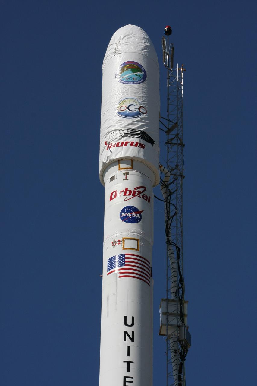 VANDENBERG AIR FORCE BASE, Calif. --  On Launch Complex 576-E at Vandenberg Air Force Base in California, NASA's Orbiting Carbon Observatory, or OCO, spacecraft awaits a GN2 instrument purge flow test in preparation for launch Feb. 24.  The spacecraft sits atop Orbital Sciences' Taurus XL rocket. At right is a portion of the umbilical tower attached to the upper stack.  The spacecraft sits atop Orbital Sciences' Taurus XL rocket. At right is a portion of the umbilical tower attached to the upper stack. The spacecraft will collect precise global measurements of carbon dioxide (CO2) in the Earth's atmosphere. Scientists will analyze OCO data to improve our understanding of the natural processes and human activities that regulate the abundance and distribution of this important greenhouse gas.  Photo courtesy of Jim Stowers, Orbital Sciences