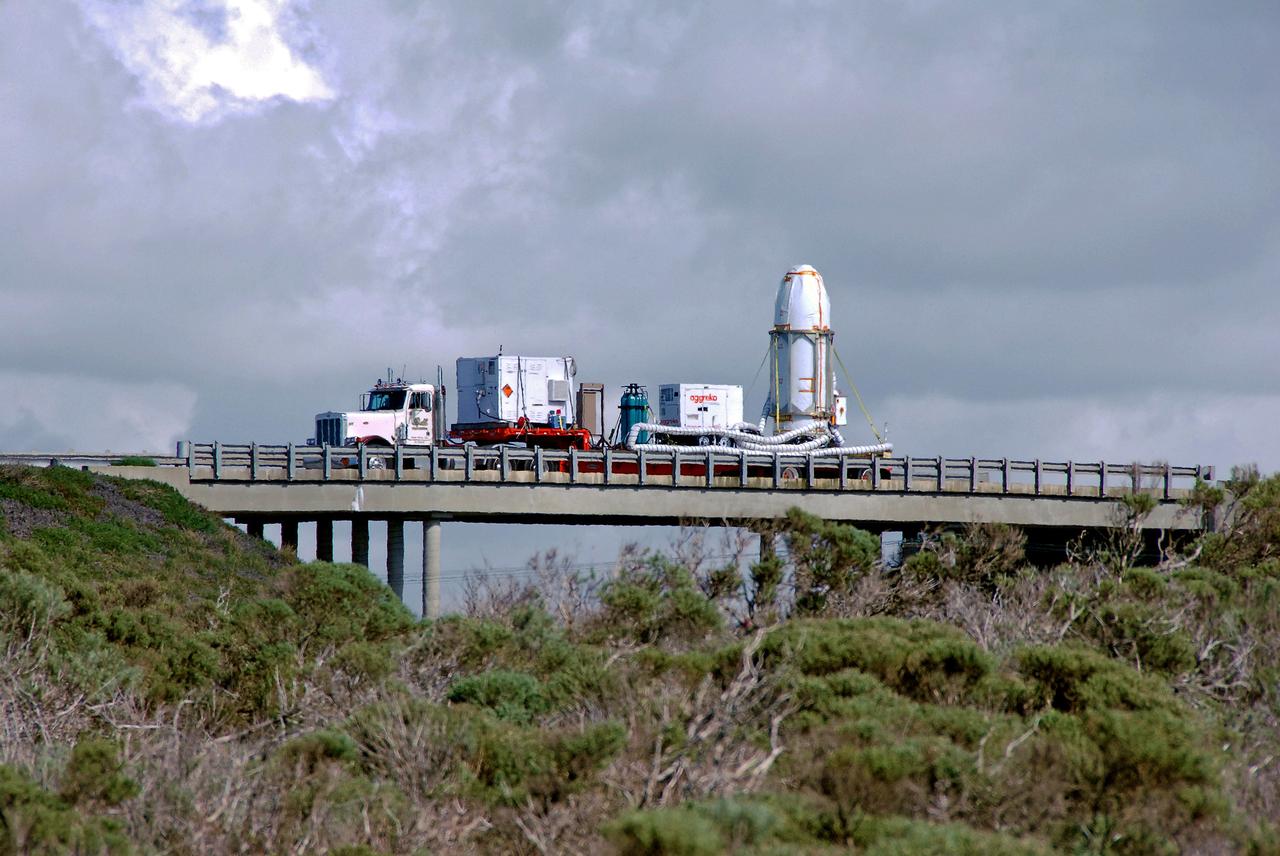 VANDENBERG AIR FORCE BASE, Calif. --  At Vandenberg Air Force Base in California, the transporter holding NASA's Orbiting Carbon Observatory, or OCO, heads for Launch Complex 576-E. OCO will collect precise global measurements of carbon dioxide (CO2) in the Earth's atmosphere. Scientists will analyze OCO data to improve our understanding of the natural processes and human activities that regulate the abundance and distribution of this important greenhouse gas. OCO is scheduled to launch Feb. 24 aboard an Orbital Sciences' Taurus XL rocket.  Photo credit: NASA/VAFB