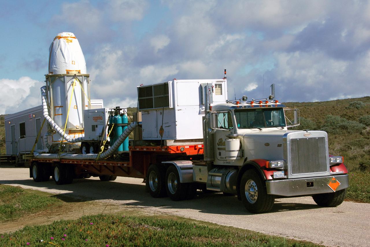 VANDENBERG AIR FORCE BASE, Calif. --  At Vandenberg Air Force Base in California, the transporter holding NASA's Orbiting Carbon Observatory, or OCO, heads for Launch Complex 576-E. OCO will collect precise global measurements of carbon dioxide (CO2) in the Earth's atmosphere. Scientists will analyze OCO data to improve our understanding of the natural processes and human activities that regulate the abundance and distribution of this important greenhouse gas. OCO is scheduled to launch Feb. 24 aboard an Orbital Sciences' Taurus XL rocket.  Photo credit: NASA/VAFB