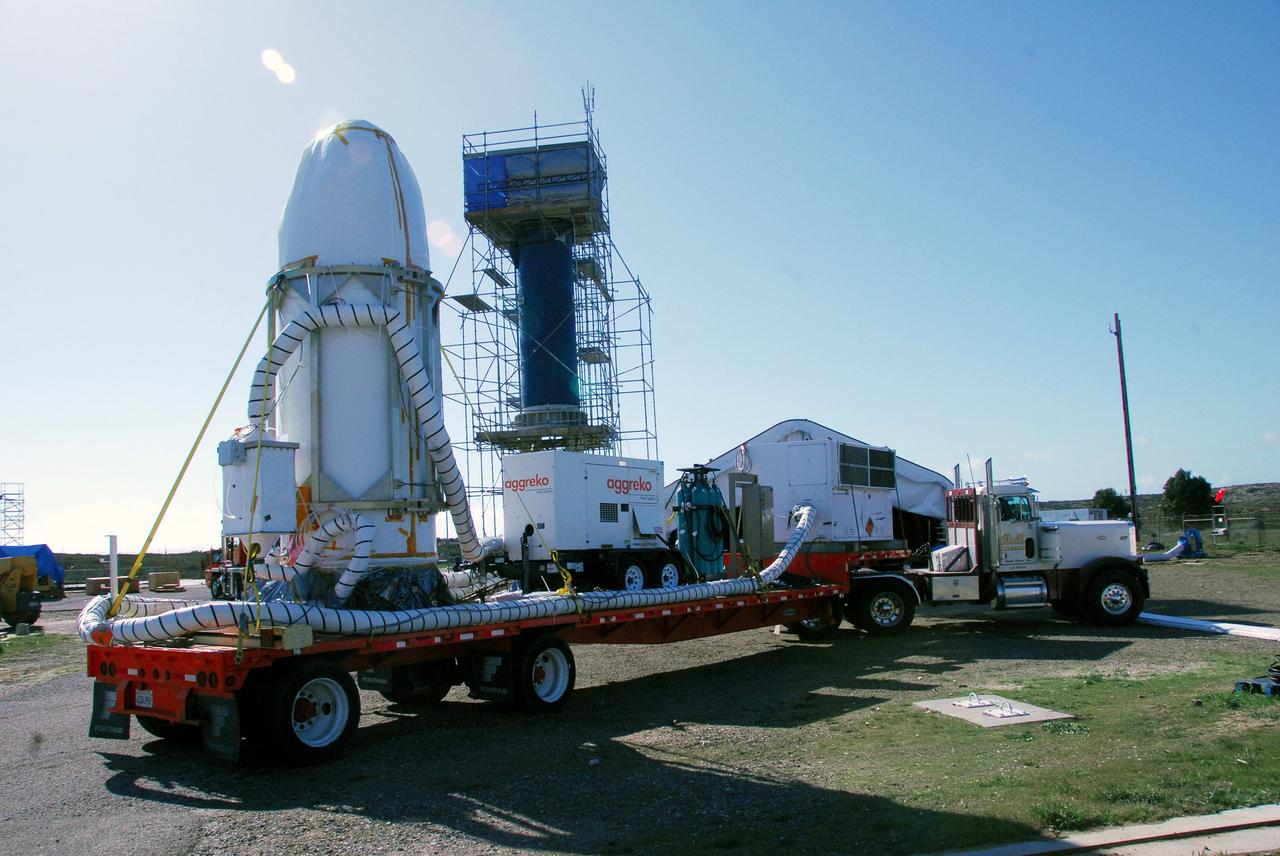 VANDENBERG AIR FORCE BASE, Calif. --  At Vandenberg Air Force Base in California, the transporter holding NASA's Orbiting Carbon Observatory, or OCO, arrives on Launch Complex 576-E. OCO will collect precise global measurements of carbon dioxide (CO2) in the Earth's atmosphere. Scientists will analyze OCO data to improve our understanding of the natural processes and human activities that regulate the abundance and distribution of this important greenhouse gas. OCO is scheduled to launch Feb. 24 aboard an Orbital Sciences' Taurus XL rocket.  Photo credit: NASA/VAFB