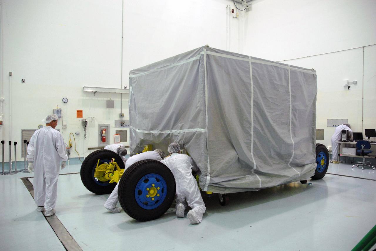 CAPE CANAVERAL, Fla. – At the Astrotech payload processing facility near NASA's Kennedy Space Center in Florida, workers prepare to remove the cover from around NASA's Lunar CRater Observation and Sensing Satellite, known as LCROSS. The satellite's primary mission is to search for water ice on the moon in a permanently shadowed crater near one of the lunar poles. LCROSS is a low-cost, accelerated-development, companion mission to NASA's Lunar Reconnaissance Orbiter, or LRO. At Kennedy, the two spacecraft will be integrated with an Atlas V launch vehicle and tested for final flight worthiness. LCROSS and LRO are the first missions in NASA's plan to return humans to the moon and begin establishing a lunar outpost by 2020. Launch is no earlier than April 24. Photo credit: NASA/Tim Jacobs