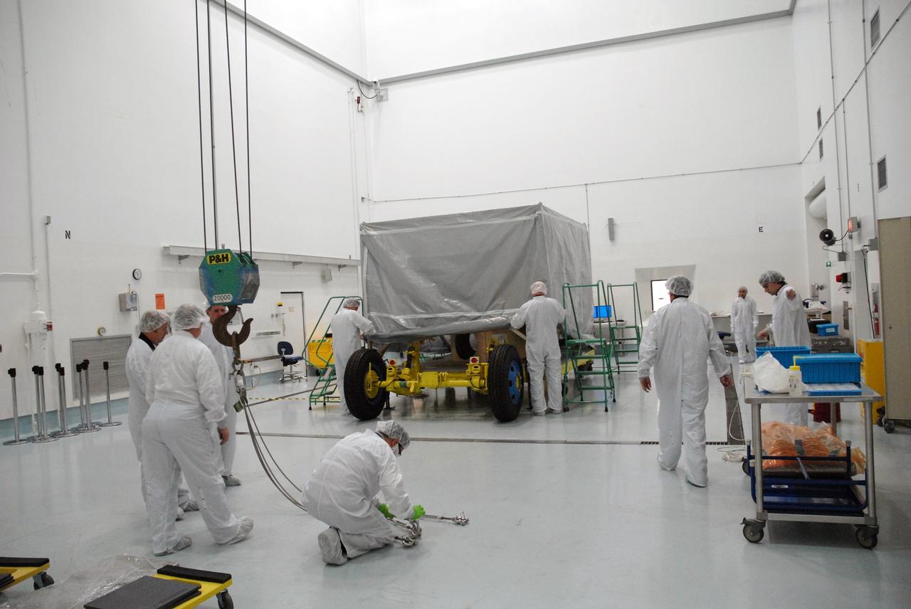CAPE CANAVERAL, Fla. – At the Astrotech payload processing facility near NASA's Kennedy Space Center in Florida, workers prepare to remove the cover from around NASA's Lunar CRater Observation and Sensing Satellite, known as LCROSS. The satellite's primary mission is to search for water ice on the moon in a permanently shadowed crater near one of the lunar poles. LCROSS is a low-cost, accelerated-development, companion mission to NASA's Lunar Reconnaissance Orbiter, or LRO. At Kennedy, the two spacecraft will be integrated with an Atlas V launch vehicle and tested for final flight worthiness. LCROSS and LRO are the first missions in NASA's plan to return humans to the moon and begin establishing a lunar outpost by 2020. Launch is no earlier than April 24. Photo credit: NASA/Tim Jacobs