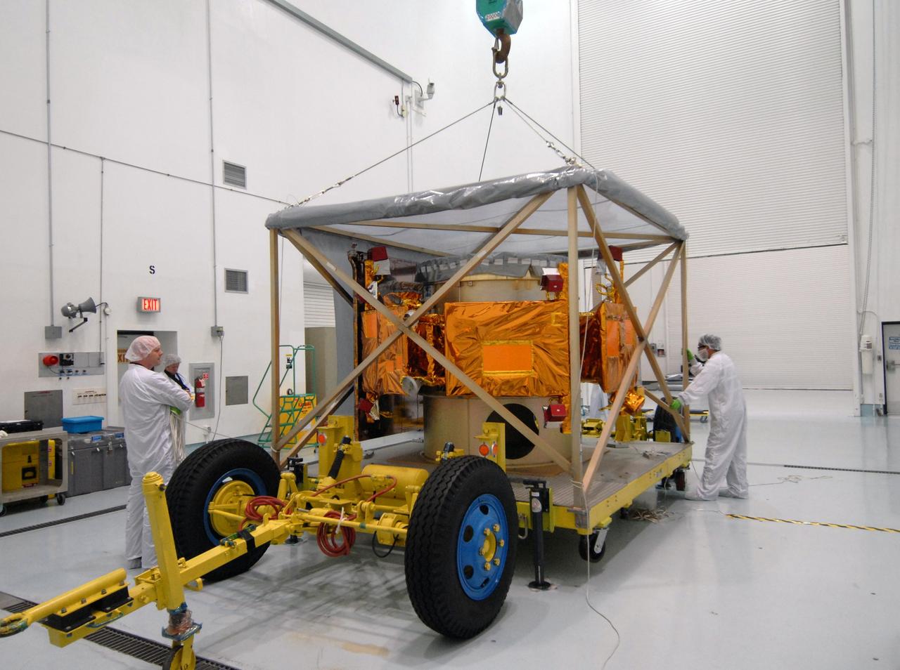 CAPE CANAVERAL, Fla. – At the Astrotech payload processing facility near NASA's Kennedy Space Center in Florida, a crane gets ready to lift the shipping cage from around NASA's Lunar CRater Observation and Sensing Satellite, known as LCROSS. The satellite's primary mission is to search for water ice on the moon in a permanently shadowed crater near one of the lunar poles. LCROSS is a low-cost, accelerated-development, companion mission to NASA's Lunar Reconnaissance Orbiter, or LRO. At Kennedy, the two spacecraft will be integrated with an Atlas V launch vehicle and tested for final flight worthiness. LCROSS and LRO are the first missions in NASA's plan to return humans to the moon and begin establishing a lunar outpost by 2020. Launch is no earlier than April 24. Photo credit: NASA/Tim Jacobs